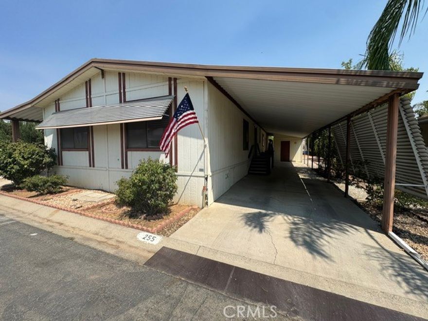 Wonderful opportunity to own a 2 bedroom/2 bathroom with attached shed in the 55+ senior community of Hillside Estates! This home is ready for your imagination to transform it into your perfect dream home! The park walking trail is conveniently located behind the home.  Two bedrooms, two bathrooms with a spacious living area with fireplace and open to the kitchen which has ample storage cabinets, brand new oven/stove, and cute kitchen countertop for casual dining.  There's also another dining area by the built-in hutch connected to the front living room. The carport on the right offers covered space for your vehicles, and there's a built-in shed available for storage along with a covered porch on the left side for additional entertaining space outside. Some simple flooring and paint would make this house completely transform into a lovely place to call home! The Hillside Estates offers a clubhouse and a pool for convenience and it's a very quick drive to shopping, restaurants, and the freeway!