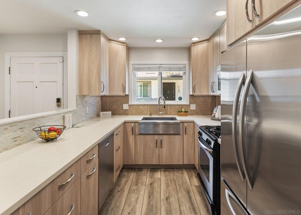 Welcome home to this charming single-level, end-unit condo offering 2 bedrooms and 2 full bathrooms in a desirable Escondido community. Thoughtfully updated and move-in ready, this home blends comfort, style, and convenience. Inside, you’ll love the modern kitchen featuring custom cabinetry with slide-outs, quiet-close drawers, Lazy Susan storage, and stainless steel appliances. Nearby, the hall hosts the full-size washer and dryer, a linen closet, and an instant water heater for added convenience. The spacious primary bedroom includes a beautifully updated bath with a walk-in shower, while the second bedroom and bath provide plenty of flexibility for family, guests, or a home office. The open living and dining area is warmed by a cozy fireplace situated perfectly between the spaces, creating an inviting atmosphere for gatherings. Stay comfortable year-round with mini-split systems in the living room and both bedrooms, along with elegant ceiling fans throughout. Step outside to enjoy your private patio, perfect for morning coffee or evening relaxation. Additional highlights include one assigned parking space in a shared garage tucked away at the back of the community, plus access to a community pool and spa—the ideal place to unwind and enjoy Southern California living. VA approved community! The spacious primary suite includes a beautifully updated bath with a walk-in shower, while the second bedroom and bath provide plenty of flexibility for family, guests, or a home office. The open living and dining area is warmed by a cozy fireplace situated perfectly between the spaces, creating an inviting atmosphere for gatherings. Stay comfortable year-round with mini-split systems in the living room and both bedrooms, along with elegant ceiling fans throughout. Step outside to enjoy your private patio, perfect for morning coffee or evening relaxation. Additional highlights include one assigned parking space in a shared garage tucked away at the back of the community, plus access to a community pool and spa—the ideal place to unwind and enjoy Southern California living. VA Approved Community!