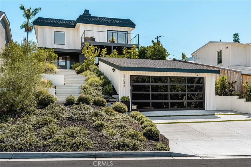 Welcome to this stunning 4 bedroom, 3.5 bath home showcasing a complete down-to-the-studs remodel finished in 2024. Every detail has been thoughtfully designed with high-end upgrades, including a recently updated roof, windows and doors, full HVAC system and ducting, tankless water heater, custom cabinetry, and French oak hardwood flooring. The spacious floor plan offers two bedrooms upstairs and two downstairs, with three bedrooms featuring en-suite baths for ultimate comfort and flexibility.

The chef’s kitchen is a true centerpiece, with custom white oak cabinetry, built-in Miele refrigerator and freezer, Bosch dishwasher, Thor 36” gas range, a 7-foot island, and striking porcelain countertops and backsplash. Upstairs, the primary suite is a private retreat with a balcony offering ocean views, a spa-like bath with freestanding tub, and a 200 sq. ft. walk-in closet with custom built-ins. The upstairs laundry adds convenience, while outside you’ll enjoy mature olive trees along with lemon, lime, fig, guava, and orange trees for a touch of charm.

This move-in ready home blends timeless design with modern luxury, offering a rare opportunity to own a turnkey property with every upgrade less than a year old.