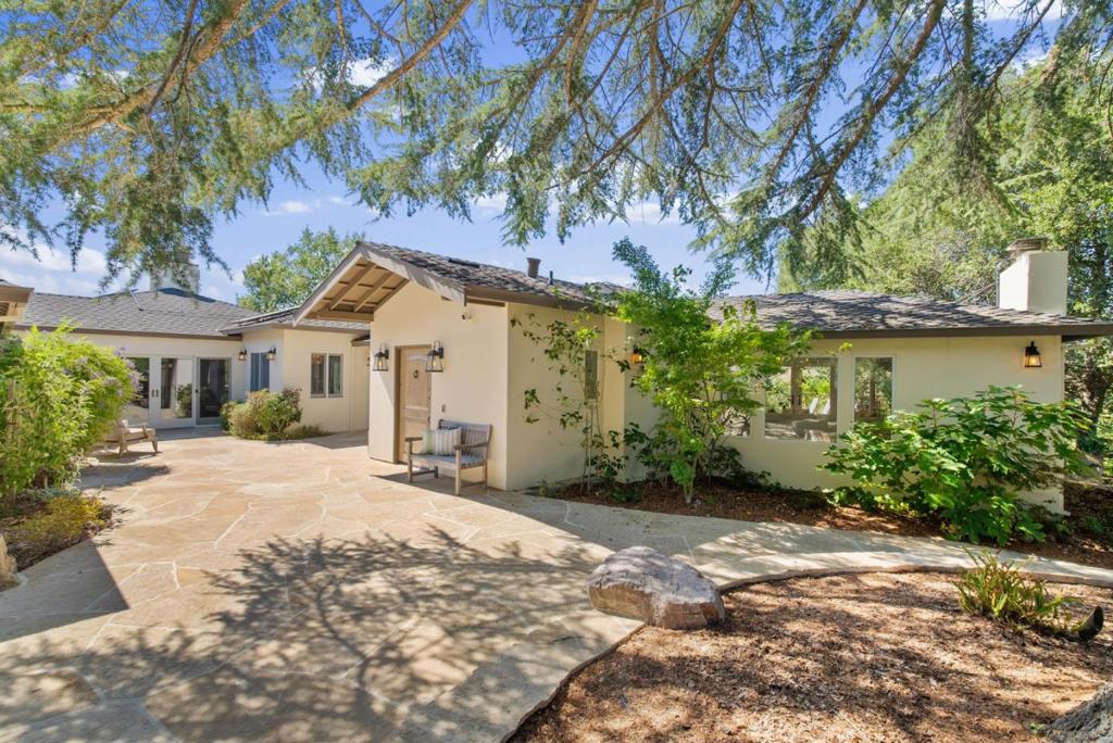 Experience the ultimate Los Gatos lifestyle with panoramic valley views, resort-style amenities, and a turnkey single-story home, all less than five minutes from town. Arguably one of the finest estate property in Los Gatos, this fully fenced and gated retreat offers unmatched privacy and is designed for large-scale entertaining. Meandering trails wind through organic fruit trees, custom enclosures, and landscaped grounds with sunset vistas. Outdoor amenities include bocce, volleyball, swimming, and multiple gathering areas. The recently updated home is centered around a beautiful courtyard entry and features spacious bedrooms, a serene office, and multiple entertainment spaces. Expansive Brazilian Ipe decking surrounds the residence, framing sweeping hillside views. Located minutes from Los Gatos High, fine dining, and shopping, and served by top-rated Los Gatos schools. A lot subdivision is underway giving you the option of purchasing the existing home with 7.6 acres for $7.2M, or acquire the full 9.6-acre property and complete the lot split yourself to capture added value. The separate 2-acre parcel (pending approvals) is listed for $1.8M, with potential to divide into two additional estate-quality view lots.