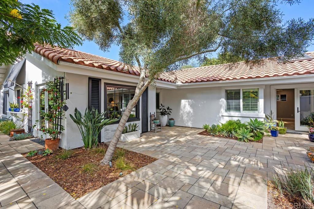Embrace sea breezes and bright sunshine in this stunning single-story residence overlooking the Lomas Santa Fe Championship Golf Course. Thoughtfully designed for year-round indoor/outdoor living, this private and exceptional home has been recently remodeled and offers the ultimate in a great Southern California lifestyle. Perfect for entertaining, the bright and airy great room features high ceilings, a fireplace, and La Cantina doors that open seamlessly to an entertainer’s dream backyard. A charming tropical courtyard sets the tone as you enter this stylishly updated home with four bedrooms, two baths, a gourmet kitchen, travertine floors, custom bathrooms, central A/C, and paid solar-for house and pool. Additional highlights include an attached two-car garage and an expansive adjacent parking area with room for RV or boat storage. The resort-style backyard boasts a solar-heated Pebble Tec pool and spa with cascading waterfalls, a spacious covered cabana with fireplace and built-in BBQ island, and a scenic terrace overlooking the golf course. Professionally landscaped and spanning over half an acre, the grounds offer endless possibilities. Located in the prestigious Isle Verde West community, this coastal retreat is just minutes from shopping, dining, award-winning schools, the Cedros Design District, and some of California’s most beautiful beaches. No HOA or MR fees.