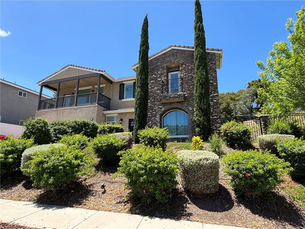 Beautiful Corona home in the Orchard Glen neighborhood, located within walking distance to the Skyline Trailhead. On the first floor you will find an office with coffered ceiling & custom lighting, a main floor bedroom and bathroom with a walk-in shower. The kitchen has granite counters, stainless steel appliances, a large kitchen island, a large walk in pantry and is open to both the dining area as well as the family room. The family room has a gas log fireplace and a multi-slide glass door that opens onto a covered patio with a view of the pond and waterfall in the backyard. Wood floors though the first floor. Upstairs is a large loft with a projector and screen, laundry room, 4 more bedrooms including a Jack and Jill bathroom. The primary suite has a large walk in closet with built in organizers & pendant lighting, a walk in shower, soaking tub and 2 vanities. The backyard has an above ground spa, shed and a nice sized side yard.