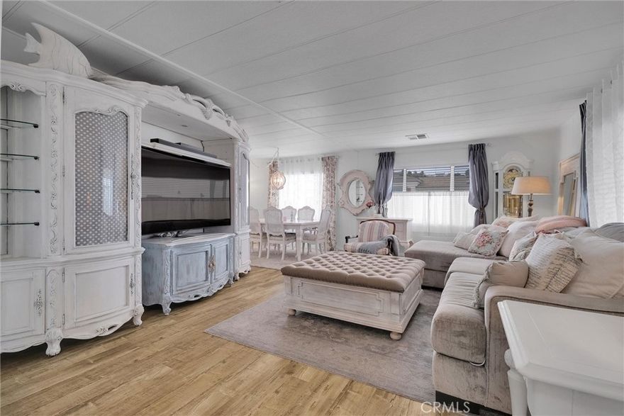 A Beautiful Doublewide Mobile Home with Beach Cottage Design Accents, Magnanimous Views of the DTLA City Lights and Bluff Views all the way to the Harbors! Feel that Ocean Breeze at the top of the Hillside where thiis completely and recently Upgraded home lies in the much sought after Skyline Mobile Park! You will exhale with peace and tranquility when you enter this Gorgeous and Affordable Home! From the scent of the front garden entrance with their David Austin Roses and the scattered Lavender Mexican Sagebrush Flowers, to the Patio Deck Entrance with an invitation to this Gloriously Upgraded Home, with pine composite wood flooring and the freshly painted white paneled wooden walls. The Living room is comfortably spacious and connects to the dining room with it;s white wooden hanging lamp, nearby newly installed Blinds to enjoy the western sunlight and some Rose patterned curtains and builtin cabinets to keep your favorite items and pictures. As you glide through, the Bright Kitchen with all it's recent upgrades, New Refrigerator, New Stove, Broiler Oven and New Gas Burner Stovetop, New Dishwasher is also connected to both the second dining room area space near the Entry way. The Bedrooms are both Relaxing and Spacious with Mirrored Closet Doors. The Master Bedroom boasts of a walk-in closet and connects to the Master Bathroom which is freshly upgraded with a splash of various Platinum and light  colored countertops and a walk in shower with clear glass doors and lots of shelfing for your personal products. There is a dedicated Laundry room which has an exit door to the covered carport space and shed, and it will bring you back to the beautiful bluff views in the back for more Ahhhh....Views!! This is a Gorgeous home and it is waiting for you to claim it!!!
