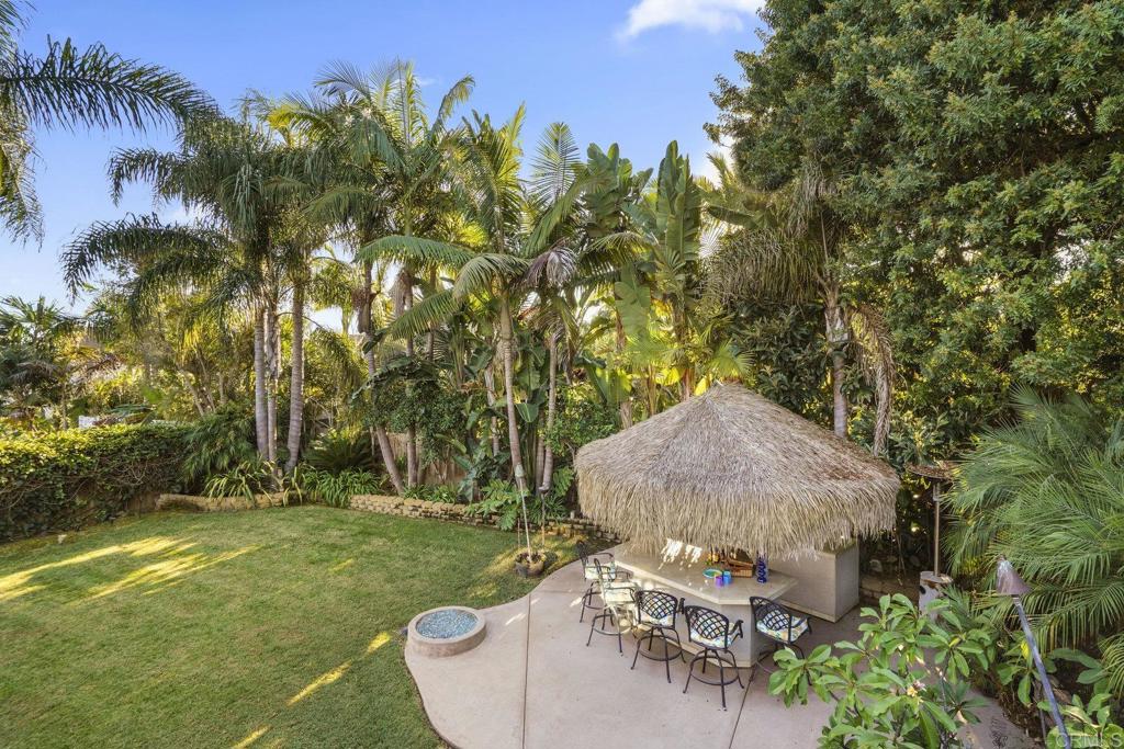 Views out to the bay, ocean, city, Coronado Bridge and Sea World fireworks are served up from this refined Pacifica home. In a nod to the location, this two story beach close home nestled on a quiet cul de sac in the sought after Pacifica neighborhood of north Pacific Beach combines island vibes with mid-century cool. Flooded with natural light and sited on a private large lot with mature landscaping, this 4 bedroom, 2.5 bath residence is minutes to the beaches and offers easy access to freeways and shopping. Featuring high-end finishes, an entertainers dream backyard anchored with a full tiki bar, fire pit and built-in grill area as well as 2 ocean view decks, one complete with a fire feature and built-in grill/kitchen allowing you to relax and chill after a day at the beach gazing at the star filled sky or watching the fireworks. The strategic use of windows and glass doors throughout the home shape the aesthetic, functionality, and connection to the outdoors. Synthesizing West Coast Modernist design with tropically influenced design combined with mid-century modern touches, this home artfully creates an intimate relationship with the ocean and is rooted in the everyday ethos that PB is globally known for—one of sand, surf, community, and connection with nature.