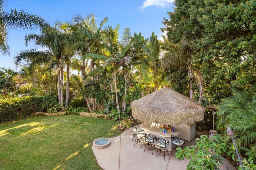 Views out to the bay, ocean, city, Coronado Bridge and Sea World fireworks are served up from this refined Pacifica home. In a nod to the location, this two story beach close home nestled on a quiet cul de sac in the sought after Pacifica neighborhood of north Pacific Beach combines island vibes with mid-century cool. Flooded with natural light and sited on a private large lot with mature landscaping, this 4 bedroom, 2.5 bath residence is minutes to the beaches and offers easy access to freeways and shopping. Featuring high-end finishes, an entertainers dream backyard anchored with a full tiki bar, fire pit and built-in grill area as well as 2 ocean view decks, one complete with a fire feature and built-in grill/kitchen allowing you to relax and chill after a day at the beach gazing at the star filled sky or watching the fireworks. The strategic use of windows and glass doors throughout the home shape the aesthetic, functionality, and connection to the outdoors. Synthesizing West Coast Modernist design with tropically influenced design combined with mid-century modern touches, this home artfully creates an intimate relationship with the ocean and is rooted in the everyday ethos that PB is globally known for—one of sand, surf, community, and connection with nature.