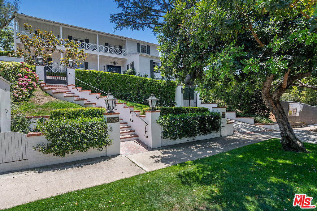 Monterey Colonial masterpiece in prestigious Little Holmby, fully furnished and available for lease at $40,000/month. This 5 bedroom estate blends 1930s architectural charm with modern luxury, meticulously restored by renowned designer Laurence Roberts. Grand formal entry opens to an elegant living room with fireplace and French doors leading to lush gardens and covered patios. A sunlit dining room, paneled den, and chef's kitchen with Sub-Zero, Wolf, and Miele appliances complete the main floor, flowing seamlessly into a spacious family room. Upstairs, four en suite bedrooms include a luxurious primary suite with spa-like bath, soaking tub, sitting area, and walk-in closet. A guest suite is privately located on the main level. Period details aboundinlaid hardwood floors, crown moldings, arched doorways, and wrought iron accents. Outdoor amenities include a resort-style pool and pavilion with outdoor shower and full bath, hillside-view deck with fireplace, al fresco kitchen and BBQ area, multiple patios, grassy yard, and gated 2-car parking. Tech-forward and security-enhanced with Sonos sound, cameras, alarm, zoned HVAC, mesh WiFi, and weekly housekeeping and pool service included. Located near UCLA, Beverly Hills, and in the Warner Elementary district, this timeless estate offers elegance, comfort, and turnkey living in one of L.A.'s most sought-after enclaves.