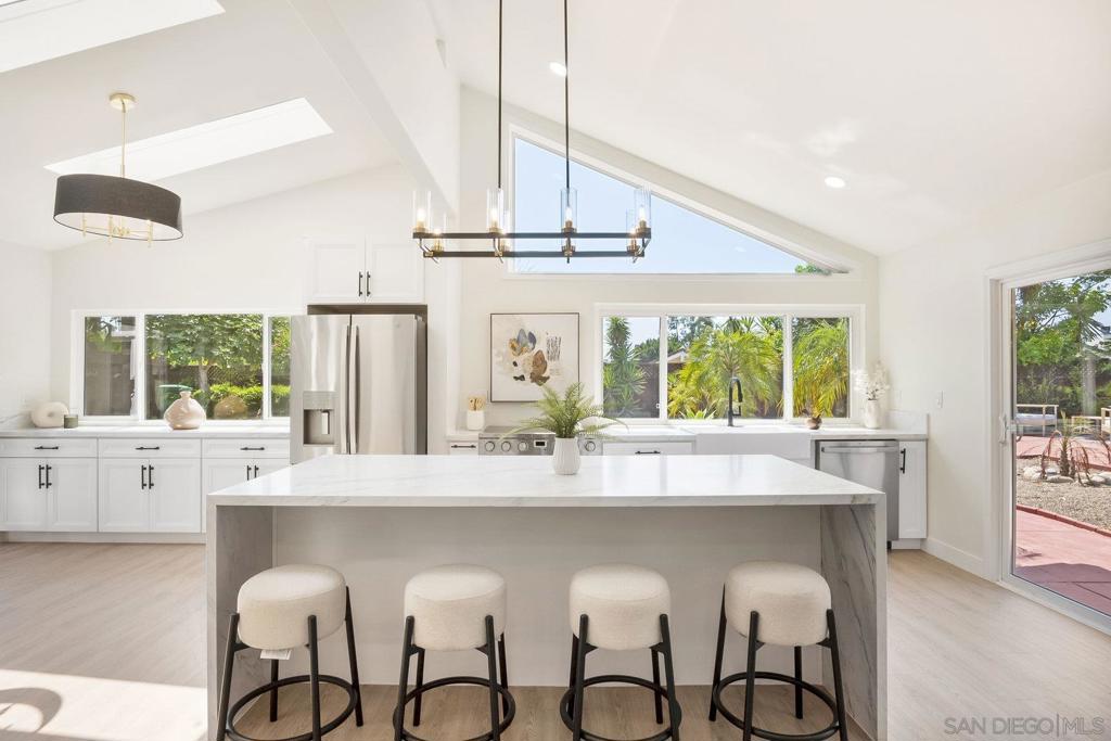 Located on a quiet cul-de-sac in one of Scripps Ranch’s most charming neighborhoods, this 4-bed, 3.5-bath home blends classic comfort with modern updates across 2,831 sq ft. The open concept layout offers 2 bedrooms on the main floor and 2 additional bedrooms upstairs—perfect for multi-gen living, guests, or home offices. A completely redesigned chef's kitchen features new cabinets, appliances, flooring, paint, smooth textured walls, light fixtures, and beautiful stylistic light fixtures, stair rail plus skylights and high ceilings throughout. All bathrooms have spa-like features including new tile, fixtures, vanities, and toilets. Outdoors, a private backyard retreat awaits—complete with mature fruit trees including black fig, orange, lime, and Meyer lemon, as well as drought-tolerant landscaping and room to entertain, garden, or add an ADU. Bonus: No HOA or Mello Roos! Located near top-rated schools, scenic parks and trails, shopping, and dining, this is a rare opportunity to own a well-cared-for home in a nostalgic, close-knit San Diego community.