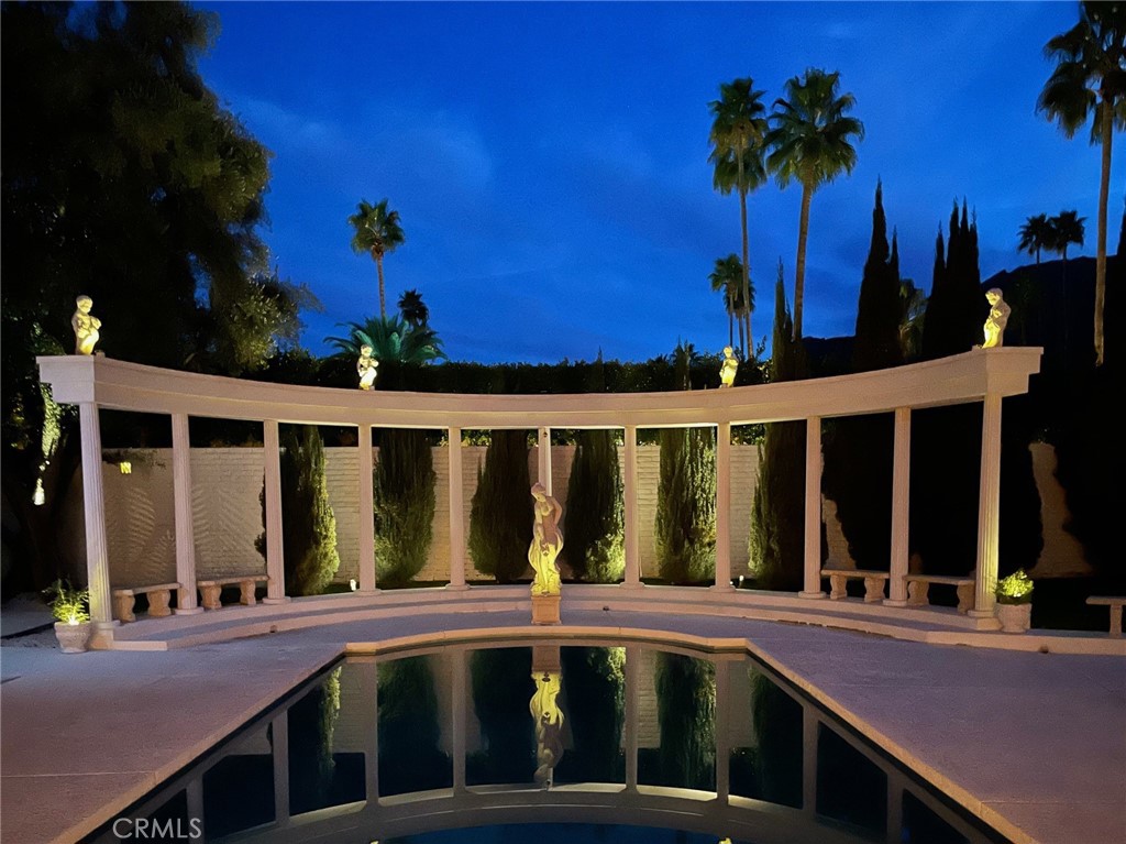 Step into a time capsule of mid-century modern perfection in the heart of Palm Springs! Designed by renowned architect John Outcalt, this 1965 gem blends retro sophistication with seamless indoor-outdoor living. Just three blocks from downtown in the coveted Historic Tennis Club district, it offers stunning views of the San Jacinto Mountains. Beyond the double-door entry, an extra-large sunken living room welcomes you with a dramatic floor-to-ceiling marble fireplace, higher ceilings, and walls of glass. Original terrazzo flooring leads to the dining area, perfectly positioned next to a fabulous vintage wet bar. The adjacent kitchen features a walk-in pantry and a separate laundry area. Two oversized primary suites offer vintage luxury with terrazzo-clad baths, sunken tubs, and private patios. A third bedroom—ideal as a media room or guest retreat—includes twin beds, a desk area, and its own terrazzo shower/tub combo. Sliding glass doors in every bedroom open to the sun-drenched pool deck, where a sparkling pool, lounge space, and breathtaking mountain views create a dreamy retreat. Private patios, an attached two-car garage, 3 cabanas and an unbeatable location near top restaurants, the Agua Caliente spa, Palm Springs Art Museum, and the famous Thursday night street fair complete this timeless escape. Select furnishings are available for purchase to keep the vintage vibes alive.
