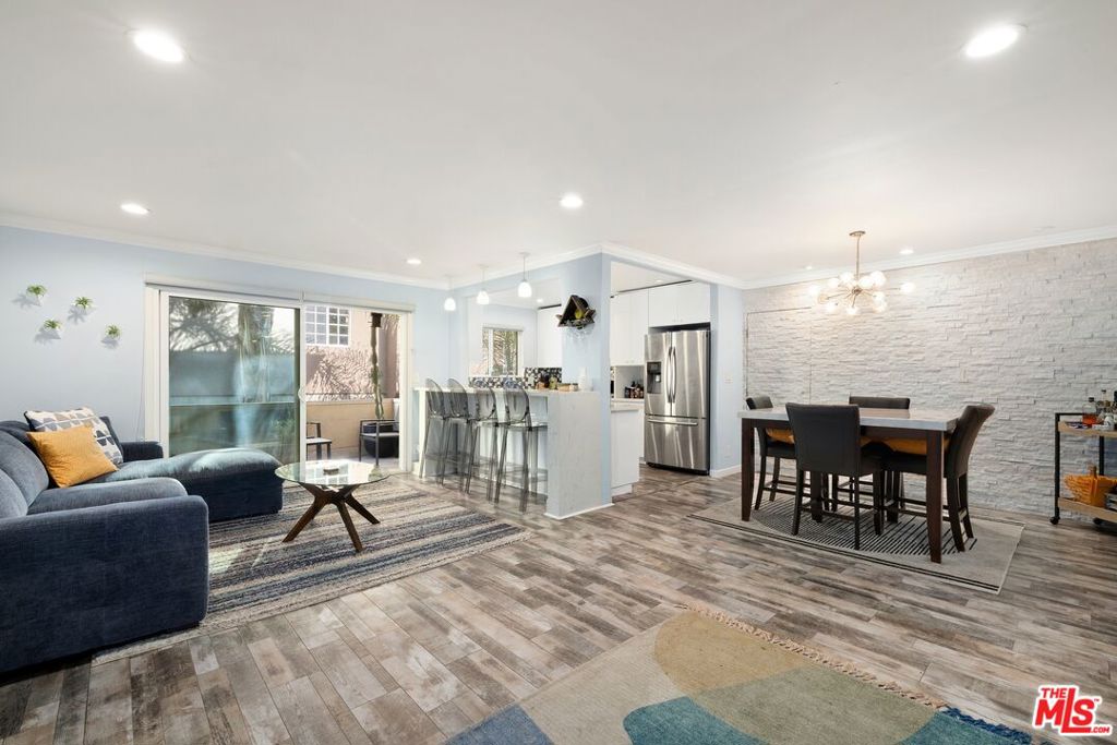 Welcome to this wonderful second-floor unit, tucked away from the street below the scenic trails of Runyon Canyon, a local see-and-be-seen favorite for decades, known for its sweeping views and expansive dog-friendly off-leash areas. Enter the foyer to discover an open-concept plan with wood laminate floors that flow from each entertaining space to the next. The living room features a sliding glass door that opens to a private balcony, perfect for relaxing with friends or dining al-fresco. The adjacent kitchen has a lengthy breakfast bar and is appointed with stainless-steel appliances, copious white cabinetry, and granite counters. Nearby, the dining area is centered by an on-trend chandelier formed of illuminated spheres, set against a calming stone accent wall. The primary bedroom is spacious, complete with en-suite bath with rainwater shower-tub combo and floating dual-sink vanity. The secondary bedroom can be utilized as an office, study, gaming/media room, and more. There is also stackable laundry in unit. Outside, enjoy the sparkling pool, whirlpool spa, and plenty of patio space. There is also secure controlled-access subterranean parking. Relish a fresh lifestyle just moments to Hollywood landmarks, nightlife, restaurants, entertainment, and more. Also available for sale.