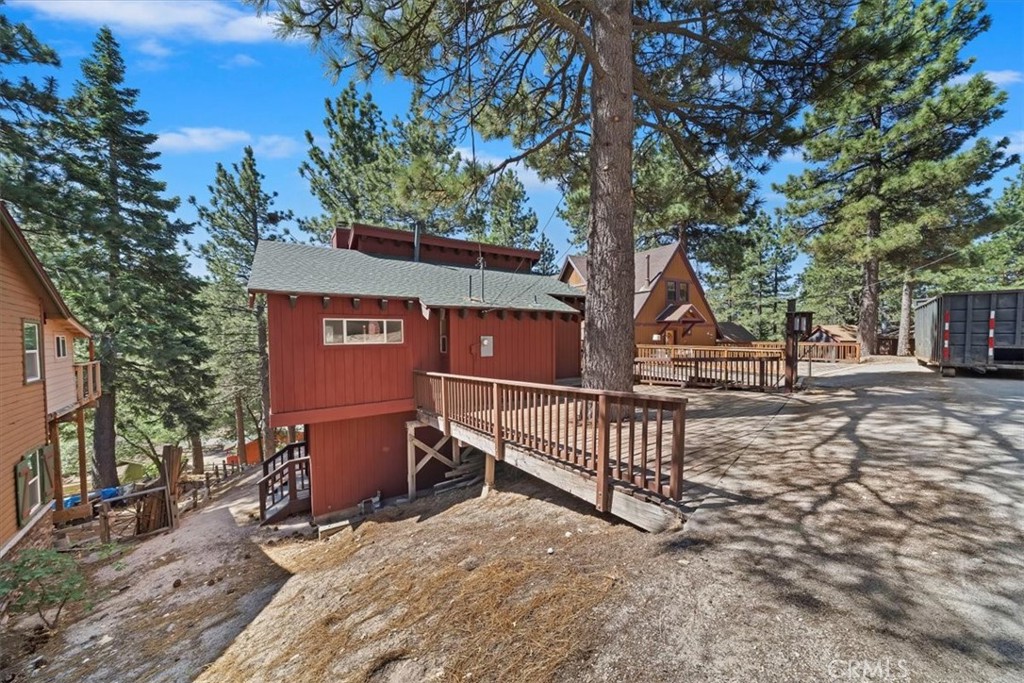 Welcome to this Beautiful updated two-story mountain retreat in the peaceful town of Green Valley Lake where you will find a warm and inviting open-concept layout that includes the entry mud room area, kitchen with new counter tops, walk-in pantry and dining area. The living room has a new wood burning stove, accent wall and hearth, loft area, bay window with ample seating, new flooring through-out, high T&G ceiling, en-suite bedroom with a walk-in closet. Step through the French doors onto a spacious entertaining deck that is perfect for savoring your morning coffee or evening beverage while taking in the serene beauty of the surrounding mountains and trees. There is a spacious family room with a stone fireplace on the lower level, sitting area, en-suite bedroom and bathroom that has been remodeled, own exterior entrance, laundry area with a work shop. Nice level entry with a parking deck for easy access. It also has new front deck railing, new roof, new interior and exterior paint. Green Valley Lake offers year-round adventure and relaxation where you can enjoy fishing, hiking, biking, swimming, and boating in a serene alpine setting. Just a short drive to the ski resorts of Snow Valley and Big Bear. Come up and escape to the peaceful charm of the Hidden Gem of the San Bernardino Mountains.