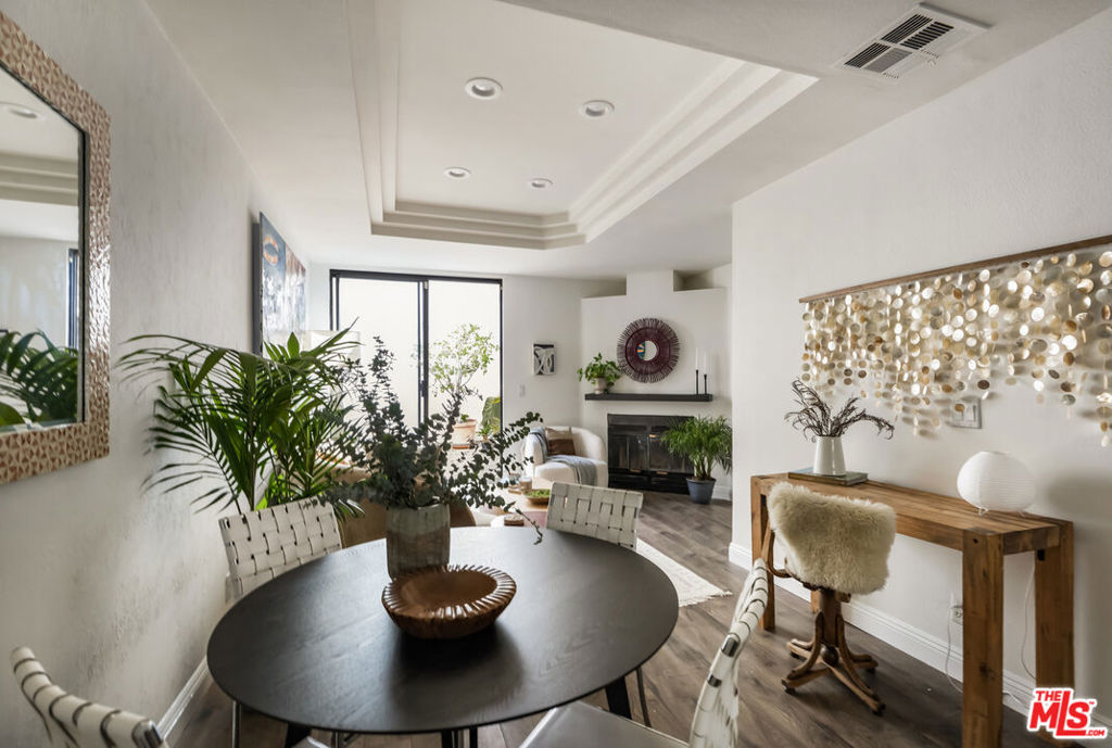 A rare opportunity to own a piece of iconic Abbot Kinney Boulevard, just a short walk from the beach, the Venice Canals, and Marina del Rey, all for under $1 million. This updated two-bedroom, three-bath townhome sits in the quiet rear corner of a gated complex, offering privacy, great natural light, and standout value in one of LA's most sought-after neighborhoods.The private front patio is perfect for morning coffee or winding down after a day at the beach. Inside, the open layout features a bright modern kitchen, wide-plank laminate flooring, a decorative gas fireplace, and glass sliders that open to a nearby shared courtyard. Upstairs, both bedrooms include custom-designed en suite baths, providing flexibility and privacy for guests, roommates, or a home office setup. Additional highlights include in-unit laundry with washer and dryer included, a brand-new HVAC system installed in 2024, two tandem underground parking spaces, extra storage, and secure building access with keyless entry. This home is pet-friendly, move-in ready, and comes with a reasonable monthly HOA. Whether you're looking for a full-time home, a low-maintenance beach getaway, or an investment property in an unbeatable location, this one checks all boxes. Your Venice story starts here.