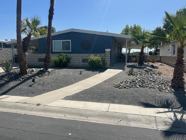 Welcome to your dream desert oasis. This house backs up to a beautiful green belt. Has many upgrades such as vinyl flooring, quartz countertops, dual pane windows and new blinds. Also has a mini bar with refrigerator to keep all your beverages cold. Step out on your back patio to enjoy mountain views. This is a 55+ community where you own the land, with very low HOA dues of $400 per month. This includes golf, pools, guard gated entrance, workout room, cable TV, high speed internet, trash pick up, and full use of all the amenities.