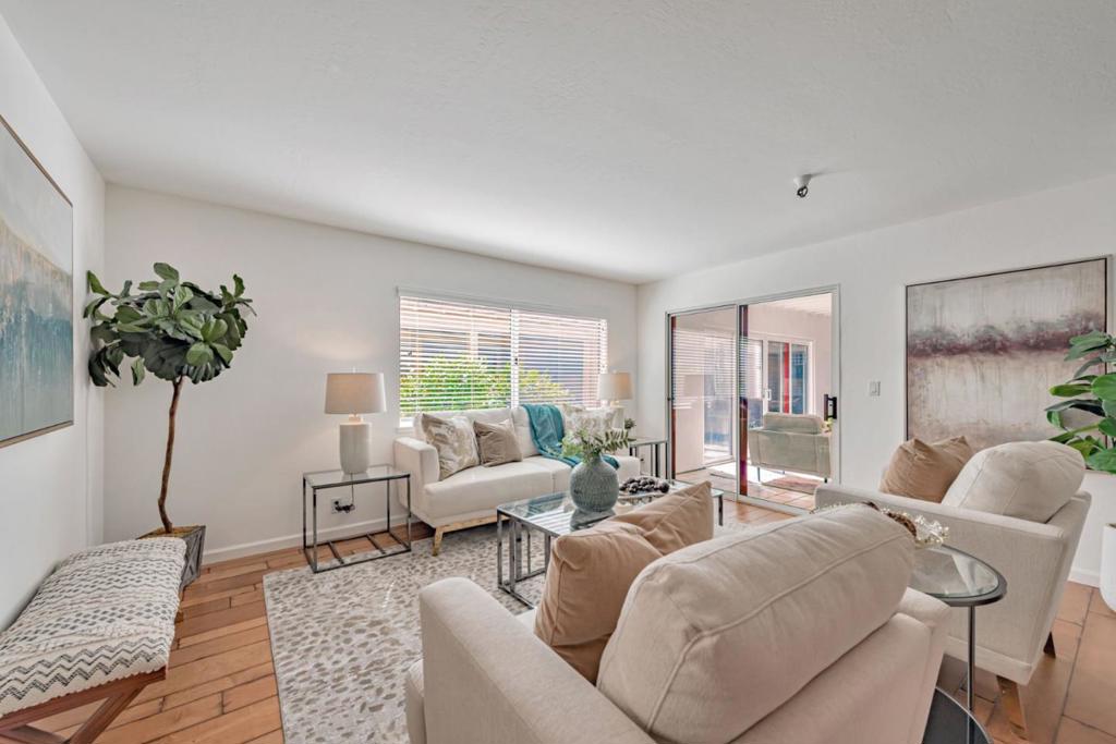 Welcome to the coveted 2 bedroom, 2 bathroom condo located in Los Gatos Commons, a resort style 55+ community. This ground level , 1136 sq ft. corner unit is convenient and has easy access. The spacious open living area greets you as you enter the home and draws you to the adjacent sunroom leading to the private garden patio to relax or entertain. Luxurious hardwood and carpet flooring add comfort and warmth. The spacious ensuite bedroom includes a dedicated bathroom and a wall of windows, The additional bedroom and bathroom is ready for guests or extra living space. Both bedrooms have closets with mirrored doors and custom organizers to maximize space. Stainless steel appliances, recessed lighting, double door pantry, granite counters, are waiting for a cooking enthusiast to enjoy the remodeled kitchen. Security gate entry and an electric gate for your assigned carport gives you peace of mind and safety. HOA amenities include a heated pool, spa, dressing area, gym, community center, library, a pool table, ping pong table and shuffleboard to exercise or socialize. Enjoy the vibrant Los Gatos community events, restaurants, shops and parks. Look no further and call this your home!