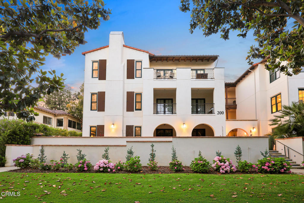 Showcasing luxury living on South Orange Grove, this top-level penthouse rests privately appointed within The Grove complex. Built in 2015 within the century-old Ambassador Gardens, this prestigious complex is neatly tucked away off the street in the heart of Pasadena. Situated within 40 acres of the former Ambassador College campus, the iconic location is celebrated by a picturesque retreat-like setting of rolling lawns, mature landscaping, walkways, running streams with waterfalls, fountains and a heated pool.This single-level unit offers an unmatched lifestyle of convenience, sophistication and tranquility on the desirable Millionaire's Row.Set on the 3rd floor, unit 307 boasts elegant custom upgrades including dramatic lighting fixtures and designer touches throughout an open concept floor plan. Gated subterranean parking, a dedicated two-car garage and guest parking serves the home with access from a secured elevator.Tall ceilings and hardwood floors span the living space.A comfortable den is set off the entry, giving options for function. A gourmet kitchen functions with large center island with sink and seating bar.The sleek space is highlighted by custom finishes including leathered marble counters, custom cabinets, wine storage, built-in Sub-Zero refrigerator and 36' stainless steel Wolf range with hood. Set for entertaining, the room opens to a comfortable breakfast area plus substantial dining space adjacent to formal living room with fireplace and stone tile feature wall. Natural light fills the space through oversized surrounding french doors with plantation shutters.A south facing patio opens from the kitchen, providing space for rest and al fresco dining with scenic views of the gardens below while Juliet balconies open to the living space inviting more tree-top views. From the living space, a wide hallway gives access to a powder bath, storage closets and laundry room.Expansive primary bedroom with attached spa-like bathroom that includes a soaking tub, large shower, water closet, dual vanities and large closet.A private patio opens from the room through french doors, giving northern views providing indoor-outdoor lifestyle. The guest bedroom currently serves as an office with built-in desk, large closet and ensuite bathroom.Rare opportunity to make yourself at home within the coveted Ambassador Gardens.Set back from the Blvd., nestled among mature trees, enjoy the remarkable privacy along with ease of access to Pasadena living.