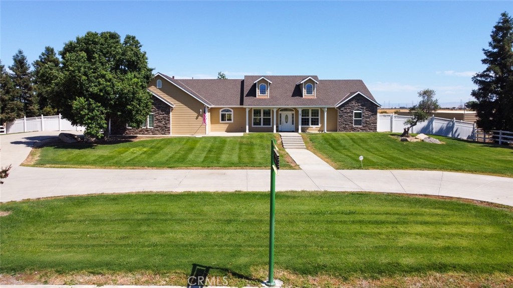 TALK ABOUT AN OASIS! Minutes from town offers a Beautiful Custom Home On 4.7 ACRES- 4 Large Bedrooms, 3 Baths. Formal Dining Room-large eat in Kitchen with island - Great Room with fireplace -Wonderful split floor plan with a large Master Bed and bath with great walk-in shower- large soaking tub overlooking cozy fireplace - large walk in closet- double sinks-wonderful laundry room with additional storage and access to outside- Lots Of Custom Woodwork thru-out house. Wonderful Eat-in Kitchen with Granite Counters, Island, Double Ovens, large circle driveway- AND the added option of being in the MID district for irrigation.- Additional pens and stalls for cows and horses -Minutes away from the new Plaza on Mission- minutes from Highway 99 AND so much