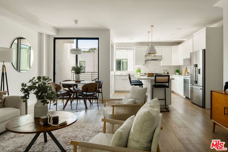 Perched within The Cliffs, a boutique collection of modern architectural homes in Echo Park, this light-filled 2-bed, 3-bath residence blends elevated design with stylish upgrades across four thoughtfully designed levels. Sunlight floods the interiors, highlighting warm wood flooring and a seamless open-concept layout. The gourmet kitchen is a true centerpiece, appointed with handcrafted Moroccan Zellige tile, an expansive quartz island, and professional-grade Fisher & Paykel and Bosch appliances. Just beyond the dining area, a private terrace with handmade Mexican Cotto terracotta tiles extends the living space outdoors. The second level hosts two serene bedroom suites, each finished with Farrow & Ball floor-to-ceiling paint for a bespoke, gallery-like aesthetic. The primary suite indulges with a spa-inspired bathroom, showcasing double vanities, a soaking tub, and a walk-in shower, evoking a boutique hotel experience. A brand-new LG washer and dryer provide seamless convenience. Crowning the home is a private rooftop retreat with a Brazilian walnut IPE deck, gas hookup, and panoramic city views, an ideal setting for entertaining under the stars. The lower level offers a direct-access two-car garage equipped with MyQ remote technology, a versatile bonus/office space with polished concrete floors, Farrow & Ball floor-to-ceiling paint, and a statement powder room adorned with Farrow & Ball hand-painted wallpaper. With modern architecture, thoughtfully curated upgrades, and enviable outdoor spaces, this home offers a turnkey opportunity to live stylishly in the heart of Echo Park, one of Los Angeles' most sought-after enclaves.