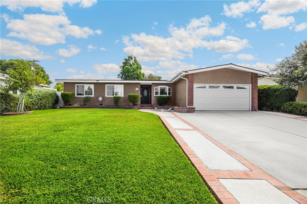 Welcome to this charming home nestled on a tree-lined street in Whittier. From the moment you arrive, you'll be captivated by the professionally landscaped front yard, lush green lawn, and inviting brick walkway shaded by a mature tree. Inside, the cozy den features a warm fireplace and beautiful engineered hardwood flooring, flowing seamlessly into an upgraded kitchen complete with stainless steel appliances, including a premium Wolf Range, stylish stone backsplash, and a spacious dinette with a picturesque Bay window, completing this inviting space.
A convenient laundry room and guest bathroom with a walk-in shower are just steps away. The large family room is ideal for entertaining, with a ceiling fan, sliding doors, and views of the backyard oasis. You'll find three generously sized bedrooms and a beautifully updated bathroom with a soaking tub and separate walk-in shower. Step outside to your private retreat featuring a sparkling pool, grassy area, tranquil koi pond, and patio space perfect for gatherings. Located within the award-winning Whittier School District and close to shops, dining, and local amenities, this home offers comfort, style, and convenience.