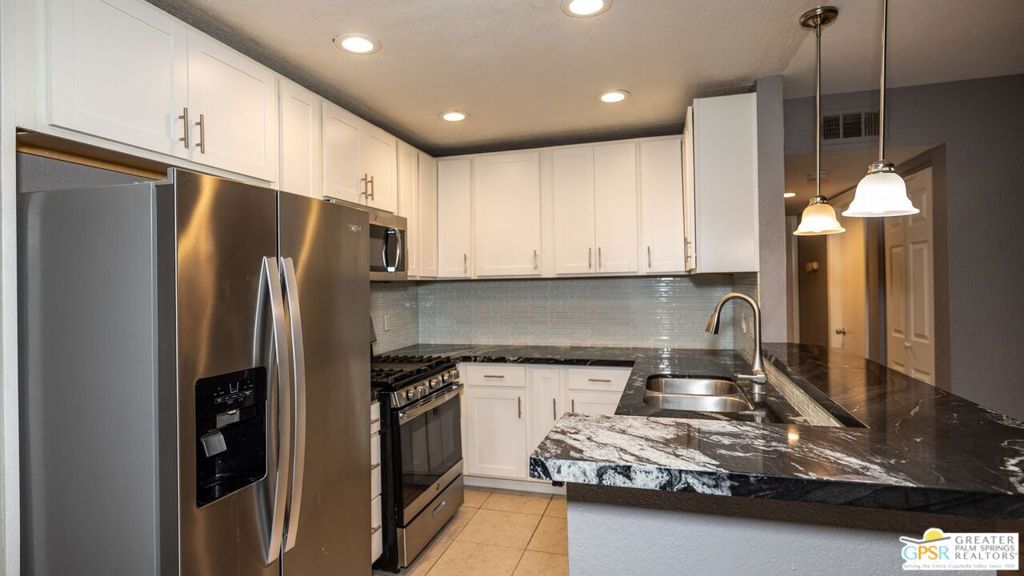 Welcome to Cathedral Springs! A vibrant and well maintained complex of 248 homes in a gated community conveniently located near dining, shopping and local amenities. This two bedroom lower level home is perfect for a homeowner not interested in lugging groceries, etc. up stairs. The kitchen, right off the dining area, boasts an open concept with stainless steel appliances. The master bedroom features its own en-suite bathroom and opens out to a patio that is perfect for enjoying morning or evening beverages while overlooking the tranquil grounds. One closet has hook ups for a stacked washer and dryer. Located just steps from one of four pools, this complex offers well-maintained open spaces, Barbeque area and a fitness center. This is the perfect combination location, serenity and desert lifestyle!