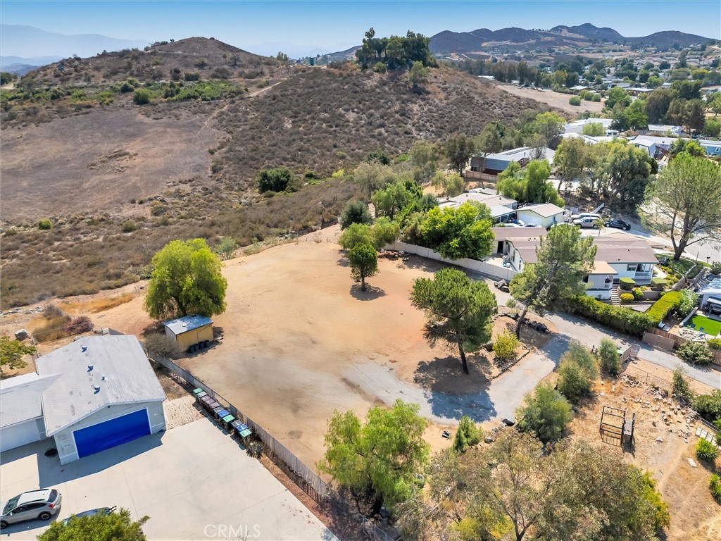 This exceptional land lot presents a rare opportunity for home builders and those seeking a prime location in the desirable FARM community. This nearly one-acre (.87) flag-shaped lot offers a blank canvas to create your dream home, boasting a flat topography and a fully fenced perimeter for added privacy and security. The property features breathtaking 270-degree views, providing stunning vistas from every angle. A long, private driveway leads to the build site, ensuring exclusivity and tranquility. This huge property is great for those with RVS, boats, or other toys, or just wants to have space for privacy. The lot previously housed a home that has since been removed, and all existing utilities are in place, including electric meters, water meters, natural gas meters, and a sewer system (not a septic system). This lot qualifies for the lot for the city's R+R (Remove and Replace) codes. This means that a significant portion of school fees and other county fees have already been paid, covering a home up to 2100 square feet. Buyers planning to build a home larger than this size should verify any additional fees with the city directly. The FARM community offers a lifestyle of leisure and recreation, with amenities such as three fishing lakes, three heated swimming pools, two parks, and various BBQ areas. This is a unique opportunity to build a custom home in a well-established community with convenient access to a variety of recreational activities.