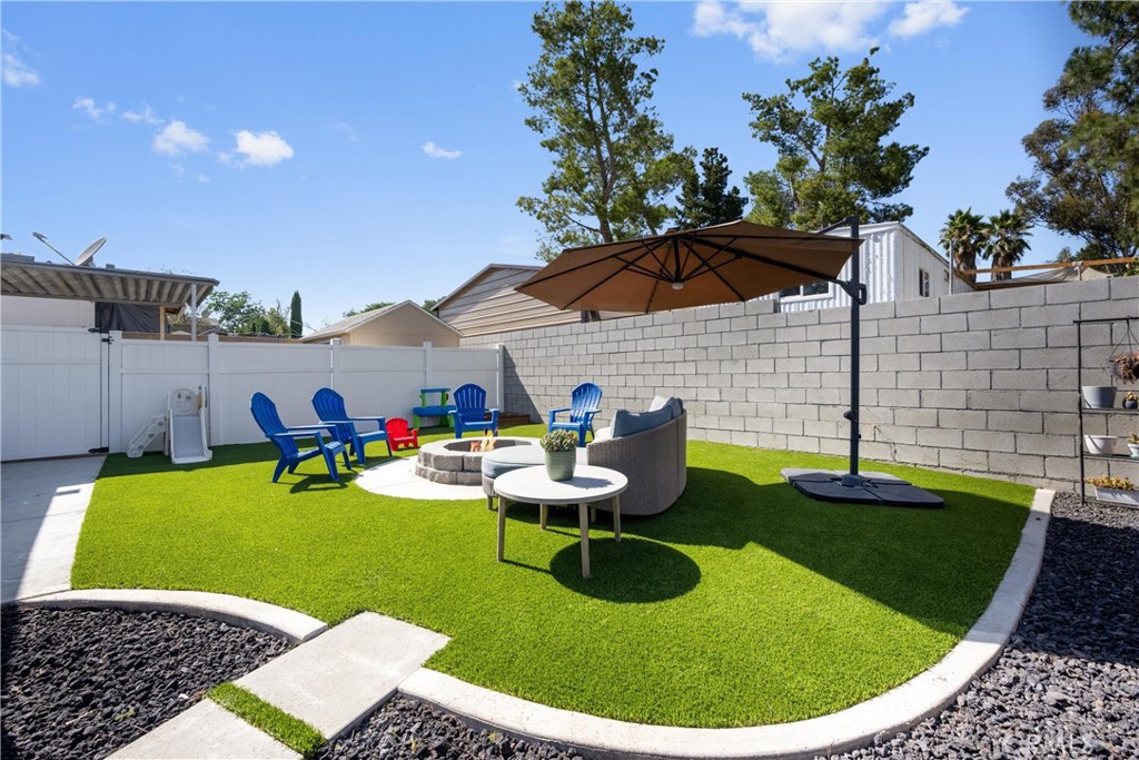 Can you believe a home THIS NICE is priced UNDER $400K? Don’t wait—schedule your showing today! This is the perfect starter home, offering both charm and functionality. From the moment you arrive, you’ll love the spacious circular driveway and deep carport with room for 5–6 vehicles, plus all your toys. A covered side patio stretches nearly the entire length of the home and leads you to a picture-perfect backyard featuring low-maintenance turf, brand new vinyl fencing, and a cozy firepit. Inside, you’re welcomed by neutral tones, updated cabinetry, and modern countertops in both the kitchen and bathrooms. The kitchen’s peninsula island creates an easy open-concept flow into the living room, perfect for entertaining or relaxing at home. The home offers 3 spacious bedrooms, including a primary suite with a private bathroom. The hallway guest bath is thoughtfully designed with a tub/shower combo and dual sinks. Conveniently located off the kitchen, the laundry area makes everyday living simple. Upgraded features throughout include dual-pane windows, keeping the home cool in summer and warm in winter. The neighborhood is charming, with surrounding homes that show pride of ownership. Plus, the high school the property is zoned for is well rated. LOW TAXES. NO HOA. AFFORDABILITY AT ITS BEST. This home qualifies for financing—reach out today to learn more!
