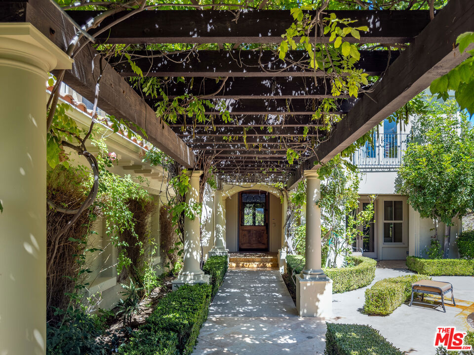 Step into charming Tuscany-inspired resort living with this 5,870 sq ft two-story estate, gracefully set on a 25,700 sq ft gated Signature Collection, designed for seamless entertaining, everyday comfort, and future growth. This 5-bedroom, 6-bath retreat offers gorgeous canyon/hills views, secured parking for 5+ vehicles, and unmatched privacy in one of Westlake Village's most desirable pockets. Inside, soaring ceilings and expansive windows flood the home with natural light, creating a warm yet refined ambiance. The open-concept design on the first floor flows seamlessly from elegant formal living and dining rooms into an oversized family room ideal for gatherings of any size. A beautiful chef's kitchen with premium appliances and custom finishes makes entertaining effortless. Also on the first floor is a dedicated home office with an en-suite bath, custom cabinetry, and a private entrance perfect for use as a guest suite. The upper level is anchored by a stunning primary suite, complete with two fireplaces, a remodeled spa-style bath, and total seclusion. Two additional en-suite bedrooms upstairs offer comfort for family or guests, Outdoor living is equally captivating, featuring two distinct backyard retreats: one with a Tuscany-style fountain, grapevine greenery, and serene seating areas; the other with a sparkling pool and waterfall, built-in BBQ, lounge with fireplace, and sweeping mountain views. This exceptional estate blends timeless Tuscan charm with modern luxury, offering both connection and retreat while delivering lifestyle, privacy, and long-term value.