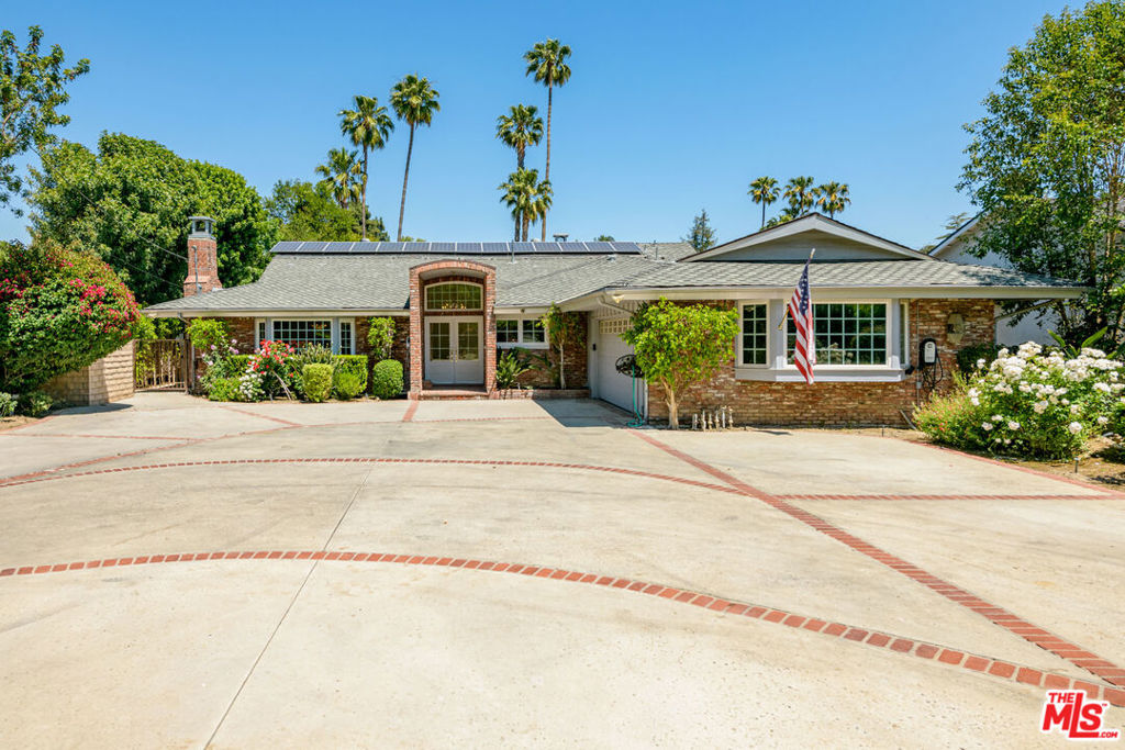 BUY NOW, SAVE BIG: $50,000 TO BUY DOWN YOUR RATE! Nestled behind private double gates on an expansive, beautifully landscaped lot, this distinguished single-story estate blends timeless traditional architecture with modern luxury and unmatched privacy. Located in Northridge's coveted Sherwood Forest enclave, the home offers rare tranquility while maintaining exceptional access to city conveniences.Featuring 4 generous bedrooms and 4.5 bathrooms, the residence is bathed in natural light and thoughtfully crafted for both refined entertaining and everyday living. The heart of the home includes spacious formal and casual living areas, a sophisticated library or home office, and a seamless indoor-outdoor flow ideal for Southern California living. Modern upgrades elevate this home's comfort and efficiency, including solar panels, three electric car charging stations, and four-zone HVAC systems with individual AC units for tailored climate control. The entertainer's backyard is a private resort-style oasis, complete with a heated pool and spa, built-in BBQ, mature greenery, and a charming pool house outfitted with a private sauna for the ultimate wellness retreat. A grand circular driveway and attached garage provide striking curb appeal and generous parking for family and guests. As well as a 45 foot RV parking and includes electrical and sewer hook ups. Tucked away on a quiet residential street, this estate is just moments from top-rated schools, shopping, dining, and offers quick access to the 405, 101, and 118 freeways providing a convenient commute to the Westside, Santa Monica, Studio City, and downtown Los Angeles. Whether hosting elegant gatherings or enjoying peaceful afternoons by the pool, this exceptional home is a rare offering that embodies the best of privacy, comfort, and classic California living.