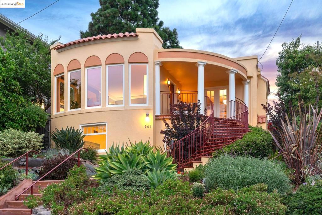 Gorgeous Grand Lake 3-bedroom, 2-bath Spanish Revival with captivating gardens, curved stairs, and portico front porch! The warm Mediterranean color palette marries with the red clay roof tiles and decorative tile accents. Easy entry is provided at the rear entrance and the lower level-in entrance. The upper level features a spacious living room with beautiful bay windows and a gas fireplace, a dining room with a built-in buffet, 2 bedrooms, 1 full bathroom, and an updated kitchen level-out to the private back yard surrounded by mature trees and raised veggie beds. The lower level offers a flexible private-entrance bedroom/bathroom/office suite, and 1-car garage with interior access. Other amenities include owned solar panels, EV charger, and many smart home features! Walkscore® = 91 “Walker’s Paradise”.