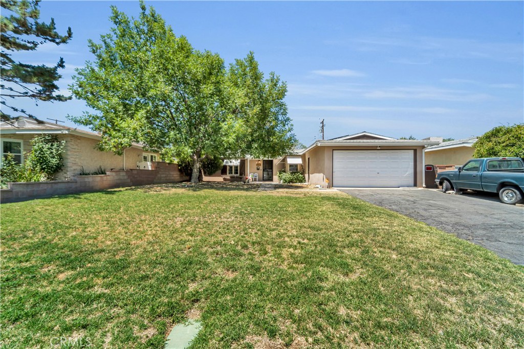 Updated and solar-equipped, this 3 bed, 2 bath single-story home is ideally located in the heart of Lancaster. With 1,278 sq ft of living space on a large 8,100+ sq ft lot, this home offers both comfort and convenience in one of the city’s most walkable neighborhoods.
Remodeled in 2019, the home features laminate flooring, recessed lighting, and an open kitchen with stainless steel appliances. Dual-pane windows, upgraded insulation, and ceiling fans add everyday efficiency. Two covered, rear patios extend the living space outdoors.
The backyard offers room to customize—garden, entertain, or expand. A long driveway and mature front landscaping add charm and functionality. Just minutes from downtown Lancaster, The BLVD Night Market, and the new Alta AV Stadium, with easy access to local dining, parks, schools, and Highway 14, this home checks all the boxes.