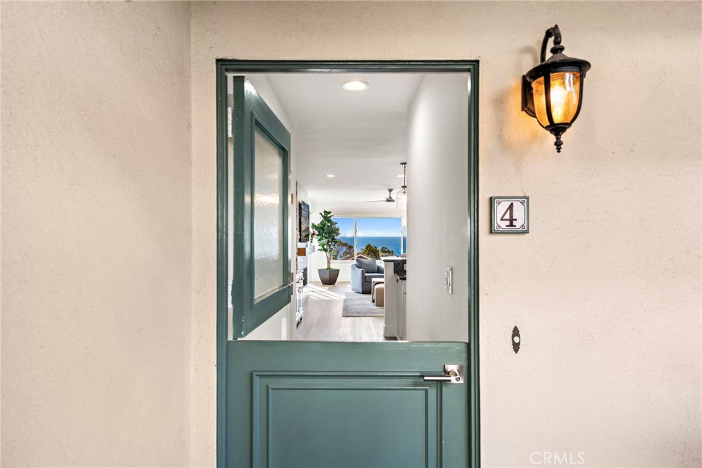 Welcome to your dream condo at 240 Moss St #4, Laguna Beach – a luxurious oasis meticulously redesigned by the acclaimed Jess Jones Design Group. This single-level, furnished home is seamlessly woven into the heart of Laguna Beach's vibrant village, offering both convenience and elegance.
As you step inside, you are greeted by sweeping panoramic ocean views that capture the enchanting beauty of the coast, extending all the way to the majestic Catalina Island. The open-concept living area, adorned with luxury vinyl plank flooring and automated Hunter Douglas shades, exudes modern sophistication. A bespoke electric fireplace wrapped in exquisite tile serves as a cozy centerpiece, perfect for relaxing evenings.
The condo's bathrooms are a testament to opulence, featuring natural marble shower, quartz countertops, and touches of Phillip Jeffries wallpaper that exude a sense of timeless elegance. Emtek hardware adds a refined touch to the cabinetry and doors, while the private balcony invites you to indulge in al fresco dining against the backdrop of the ocean's gentle whispers.
Nestled conveniently on the main level for easy access to parking, this condo is a haven for those seeking a harmonious blend of luxury and convenience. Being in close proximity to the free trolley and the renowned Moss Cove Beach, your coastal adventures are just steps away. Embrace the Laguna Beach lifestyle with this turnkey opportunity, where every detail has been crafted to perfection by the award-winning designers.
Explore this beautiful furnished condo and envision your life surrounded by the beauty and charm of Laguna Beach. Don't miss your chance to own a piece of paradise, where every sunrise and sunset feels like a masterpiece.