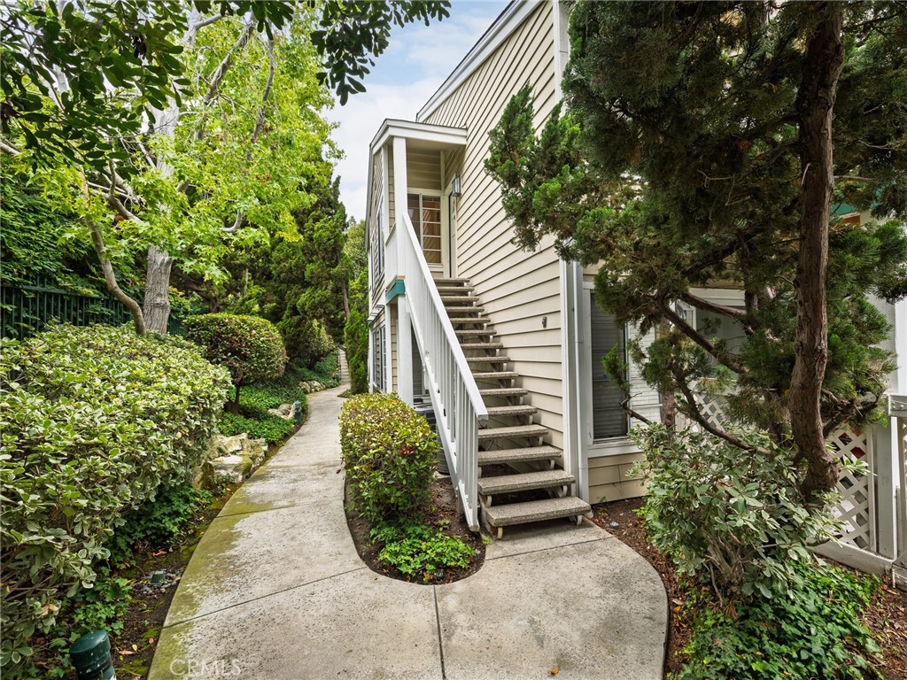 Welcome to this cheery, move in ready, UPPER 1 bedroom/1 bath unit in HARBOR GATE NORTH. This GATED COMMUNITY has beautifully maintained mature landscaping, water feature, and an inviting pool and spa. Wood flooring, a VAULTED CEILING and cozy FIREPLACE highlight the living room, which opens to a private balcony. The kitchen has new QUARTZ COUNTERS, stainless steel dishwasher, sink, refrigerator, stove and microwave. There are in-unit washer and dryer hook-ups, with washer and dryer included! The unit enjoys central AIR CONDITIONING and a spacious walk-in closet in the bedroom. There is a detached TANDEM GARAGE. The unit is conveniently located near Gate #2, which provides easy access for your guests. Conveniently located near shopping, dining and movies.