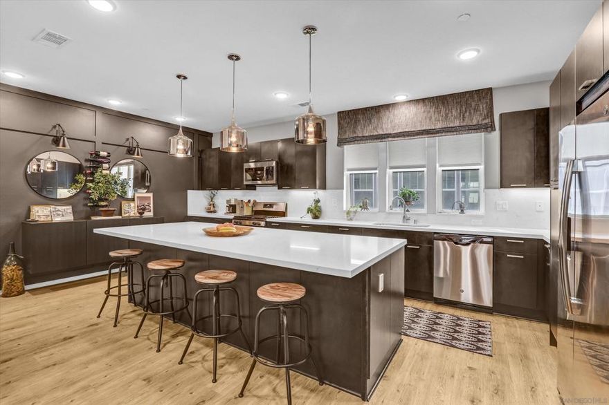 Welcome to this Playa Del Sol Model Home—a rare opportunity to own the showcase residence of this highly desirable community. Built in 2018 and meticulously cared for, this home offers unmatched value with designer-selected upgrades that highlight its status as the builder’s model.  This move-in ready 3-story condo features 2 bedrooms, 2.5 bathrooms, and a spacious 2-car garage. The gourmet kitchen is a true highlight with stainless steel appliances, quartz countertops, upgraded backsplash, modern pendant lighting, and abundant cabinetry. Throughout the home, you’ll find upgraded carpeting, luxury vinyl flooring, custom lighting, and built-in speakers. The primary suite boasts a large walk-in closet, dual vanity sinks, and a spacious walk-in shower. A washer and dryer are also included for added convenience.  Resort-style living awaits with a community offering endless amenities: a sparkling pool, relaxing spa, state-of-the-art gym, clubhouse, outdoor BBQ areas, playgrounds, and beautifully landscaped parks. Ideally located near I-805, this property offers easy access to shopping, dining, and entertainment while maintaining a peaceful residential setting.  Don’t miss this chance to own the former model home, uniquely upgraded to reflect the very best in design and quality.