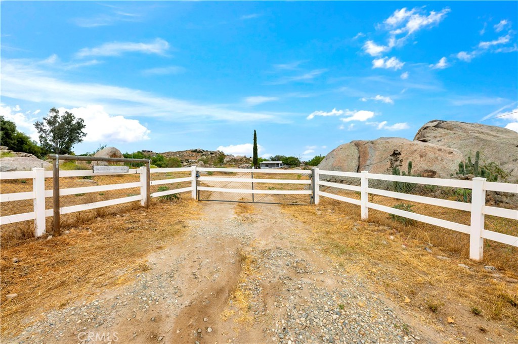GREAT STARTER RANCH ON 2.07 ACRES! Bring the horses, animals & toys! Remodeled Manufactured Home on permanent foundation with SOLAR, NEW paint inside and out, laminate flooring, custom fixtures, new windows, ceiling fans throughout, granite counter + tile accented shower & custom cabinetry in bathroom & vaulted ceilings. This charming home offers 2 bedrooms + Bonus Room, 1 bathroom, indoor Laundry & large Family Room that opens to the Kitchen & Dining area. Also, features a covered, partially enclosed sunroom. Gated entry leads to a fully fenced & cross fenced 2.07 ACRE LOT with room for RV/ Boat/ Trailer Parking, Roundpen, Arena & Barn. This property has so much potential for a perfect RANCH SETUP! Located in a tranquil setting with views of the valley & mountains. Conveniently located near the 215 Freeway. NO H.O.A. and low taxes! Hurry, this one is priced to sell!
