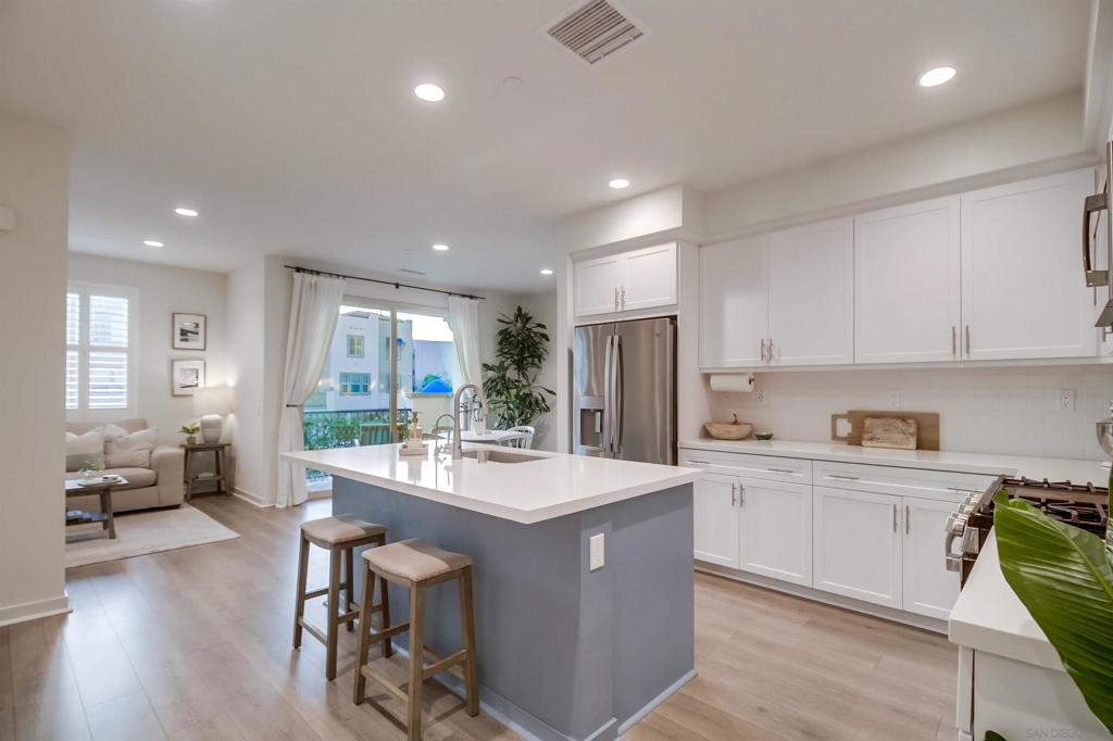 Welcome to this beautifully maintained 2-bedroom, 2.5-bath townhome offers 1,373 sq. ft. of stylish and energy-efficient living. Enjoy the benefits of a prime park-like location with serene open-space views and direct access to the community playground and BBQ area. Inside, you’ll find thoughtful upgrades including plantation shutters, a whole-house fan, a vertical shiplap accent wall, custom alcove shelving, a water filtration system, on-demand hot water, and wired for easy car charger install. The open-concept kitchen features modern finishes, and all appliances convey, including an upgraded KitchenAid dishwasher. Upstairs, each bedroom is its own private retreat: the junior suite offers an ensuite bath and walk-in closet, while the primary suite is designed for comfort and privacy. A full-size stacked washer and dryer are also included for convenience. Living in Riverview means enjoying resort-style amenities such as a pool, spa, and walking trails. This vibrant, walkable neighborhood is just steps from Santee Town Center Trolley Square, dining, shopping, and everyday conveniences. Outdoor enthusiasts will love nearby Santee Lakes, Mission Trails Regional Park, and Carlton Oaks Golf Club. With easy access to SR-52, downtown San Diego, Clairemont, and the Pacific Ocean are all less than 20 miles away. This home combines modern comfort, community lifestyle, and a central location, making it one of the best values in Santee’s growing real estate market.
