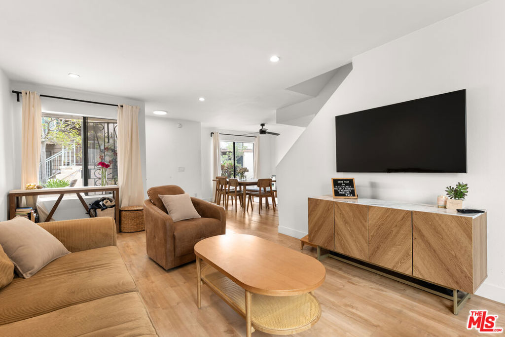 Experience the perfect blend of style and serenity in this beautifully remodeled townhouse-style residence, tucked into a quiet interior location within an exclusive, well-maintained complex. From the moment you enter, you're greeted by a fresh, contemporary aesthetic sleek white cabinetry, elegant countertops, and wide-plank vinyl wood flooring flowing throughout the open-concept living space. Natural light pours in through expansive windows, enhancing the home's warm and inviting ambiance. The spacious living room opens to a large private patio with a charming pergola an ideal setting for al fresco dining or relaxed evenings under the stars. Entertain effortlessly in the generously sized dining room, designed for gatherings both large and small. Upstairs, thoughtful upgrades continue with a side-by-side washer and dryer conveniently located between two well-appointed bedrooms. The primary suite features its own private balcony perfect for morning coffee or winding down at dusk. Recessed lighting, central HVAC with a Nest thermostat, and tasteful finishes throughout make this home completely move-in ready. Additional highlights include two parking spaces in a gated community garage with extra storage, and four guest parking spots for easy entertaining. Situated in the heart of Inglewood, you're just minutes from So Fi Stadium, The Forum, the Metro K Line, and major transit offering unbeatable access to LA's most exciting venues and conveniences. This is a rare opportunity to own a stylish, move-in ready home with versatile outdoor spaces and quiet elegance in a prime, tucked-away location. Don't miss your chance to make it yours.