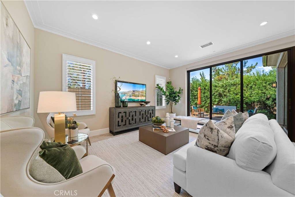 Tucked away on a premium corner lot with no neighbors on three sides, this beautifully upgraded 4-bedroom, 4-bathroom home offers both privacy and elevated living in one of Irvine’s most desirable communities. Designed with comfort and flexibility in mind, the open-concept main level features a bedroom with a full bath, ideal for guests or multi-generational living, along with a spacious great room and a chef-inspired kitchen showcasing quartz countertops, designer backsplash, and custom cabinetry. Upstairs, the home continues to impress with a generous primary suite, two additional en-suite bedrooms, and a versatile loft perfect for a home office, media space, or playroom. Throughout the home, thoughtful upgrades include engineered hardwood flooring upstairs, premium tile and fixtures, plantation shutters, whole-house water filtration, and a security system. Enjoy sweeping mountain and city views from the upper level—on clear nights, even catch a glimpse of Disneyland’s fireworks from the comfort of home. The spacious side yard offers ample room for outdoor entertaining and gardening. Set within a resort-style community featuring a pool, spa, clubhouse, parks, and walking trails, and located in the award-winning Northwood High School district, this exceptional home offers the perfect blend of location, layout, and lifestyle.