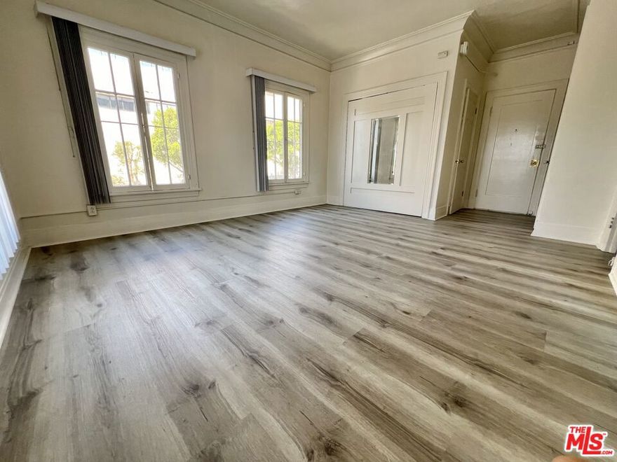 Step in to this beautifully renovated  upstairs apartment, complete with luxury plank flooring, a spacious kitchen, and on-site laundry facilities for your convenience. Absolutely stunning bathroom with chic marble-style tiled shower + tub. The massive closet with mirrored door & the separate vanity area off of the bathroom provide the essentials for comfortable living. Situated in a bustling neighborhood, residents can enjoy easy access to nearby shops, restaurants, and entertainment options. This prime location won't last long - so schedule a viewing today and make this apartment your new home! No pets allowed.