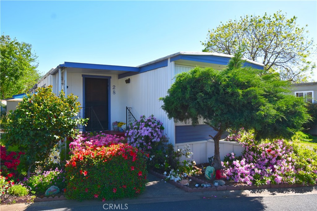 Welcome to this charming 2-bedroom, 1-bathroom manufactured home located in the desirable Lake Vista Senior Community, an inviting neighborhood for residents aged 55 and older. This lovely home features central heating and air conditioning, along with an evaporative cooler to keep you comfortable year-round. Enjoy the beautifully landscaped yard with a nice, shaded porch area, perfect for relaxing or entertaining guests. The property also includes two convenient storage sheds and covered parking underneath the attached carport. Plus, you'll love the location which is right across from the community pool, barbecue area, and laundry facilities! Also as added bonus some furniture may also be included in the sale! Come see all that this wonderful home and community have to offer!