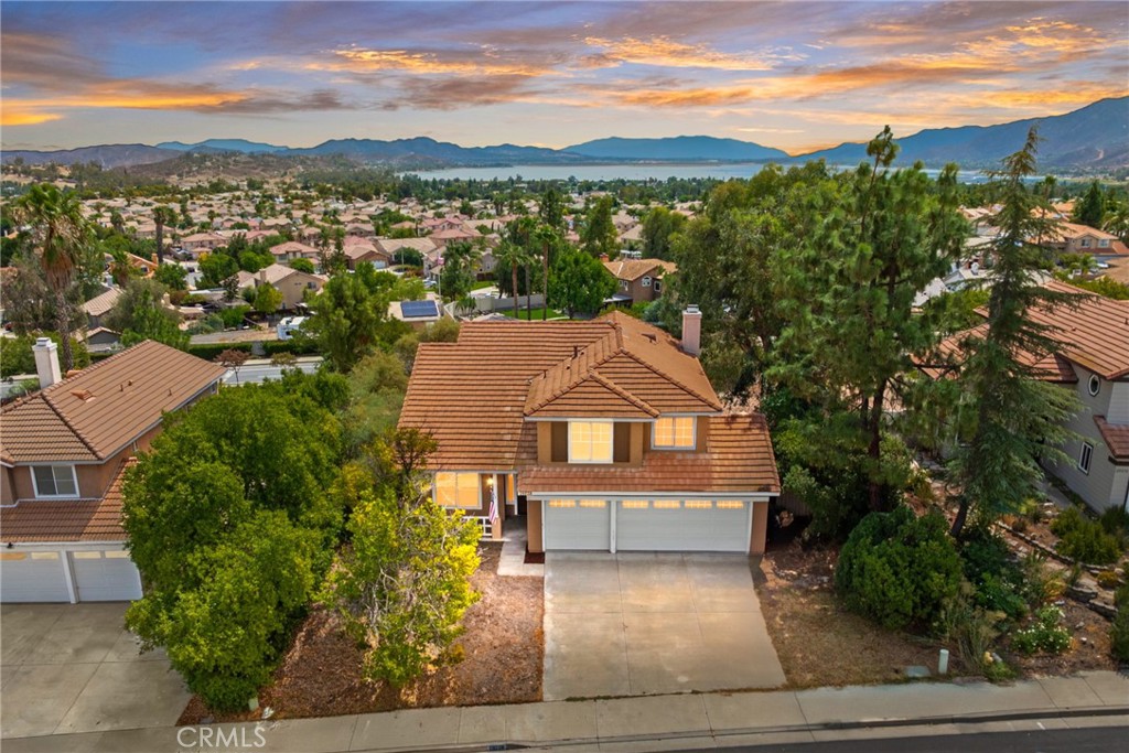 ***LOW TAXES*** Spacious 4-Bedroom Home with Lake Views & Prime Location! Welcome to this beautifully updated 2-story home offering 4 bedrooms, 3 bathrooms, and 1,914 sq. ft. of living space on an expansive 11,761 sq. ft. lot. With fresh interior paint, a bright open layout, and plenty of natural light, this home perfectly blends comfort and style. Inside, enjoy a mix of wood laminate flooring and plush carpet, soaring high ceilings, and large windows throughout. The living room features a charming fireplace, creating a cozy atmosphere for family gatherings. The kitchen opens seamlessly to the living room and includes a casual dining space, making it ideal for entertaining and everyday living. Upstairs, you’ll find four generously sized bedrooms, including a master suite with stunning views of Lake Elsinore. The spa-like master bath offers dual vanities, a soaking tub, and a walk-in shower for the ultimate retreat. The large backyard provides endless opportunities to create your dream outdoor space—whether that’s a garden, pool, or private oasis. Prime Location: Just a short walk to Summerlake Park, close to local schools, dining, shopping, and hiking trails, and less than 10 minutes to Lake Elsinore for boating, fishing, and lakeside fun. Don’t miss out on this move-in ready home with lake views and an unbeatable location! Schedule your showing today.