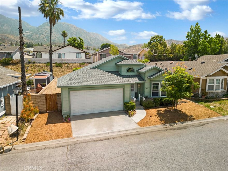 Welcome to this beautifully maintained 2-bedroom, 2-bathroom home in the highly sought-after Santiago Estates community! Step into a bright and open floor plan featuring vaulted ceilings, tile flooring in high-traffic areas, and laminate in the bedrooms and living spaces. The spacious kitchen offers generous cabinetry, a center island, and a cozy breakfast nook—perfect for casual mornings. Host guests in the adjoining dining area or unwind by the wood-burning fireplace in the inviting living room, which opens to a covered patio. The primary suite offers privacy and comfort with a walk-in closet, sliding doors to the backyard, and a spa-like bathroom with dual sinks, a soaking tub, and a separate shower. Outside, enjoy serene mountain views, a side yard, and ample space for outdoor gatherings. Additional perks include an indoor laundry room, a two-car garage with an electric roll-up door, and access to top-tier amenities: pool, spa, clubhouse, racquetball and basketball courts, playground, gazebo, and more. Located near the 210 freeway and scenic hiking trails—don’t miss the chance to make this your next home!