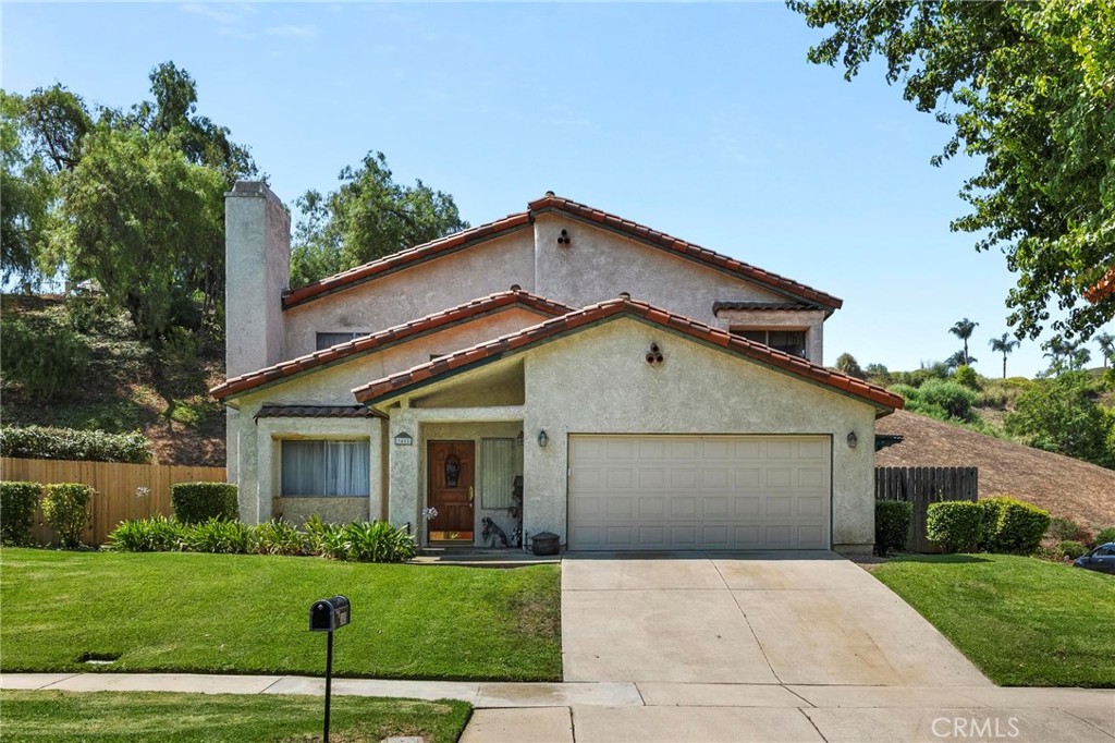 WELCOME TO THIS AWESOME HOME IN A DESIRABLE AREA OF CHINO HILLS WITH NO NEIGHBORS ON EITHER SIDE OR DIRECTLY BEHIND!! NICELY MANICURED WITH CURB APPEAL, ENTER INTO YOUR NEW HOME AND YOU ARE WELCOMED BY AN OPEN FLOOR PLAN. STEP DOWN INTO YOUR LIVING ROOM THAT HAS A COZY FIREPLACE FOR THOSE CHILLY WINTER NIGHTS. THE DINING ROOM IS IS SIZED WELL WITH BIG GLASS WINDOWS AND DOOR THAT OFFER NATURAL LIGHT AND A NICE VIEW INTO YOUR BACKYARD. THE KITCHEN IS BIG WITH LOTS OF CABINET SPACE, COUNTER SPACE AND A ISLAND WITH RUNNING WATER. THE FAMILY ROOM IS BIG AND INVITING FOR WHEN IT'S TIME TO RELAX AND ENJOY. THE BEDROOMS ARE ALL GOOD SIZE WITH CEILING FANS IN EACH ROOM. THE HALLWAY BATH HAS A SINGLE SINK WITH A SHOWER/TUB COMBO WITH ANOTHER HALF BATH DOWNSTAIRS. THE MASTER BEDROOM IS LARGE WITH PLENTY OF ROOM WITH A DOUBLE SINK MASTER BATHROOM. THE BACKYARD IS THE BIGGEST IN THE COMMUNITY!! NATURAL BEAUTY WITH PLANTS, FLOWERS AND TREES WITH AN INVINTING VIEW OF THE HILL BEHIND YOU AS WELL AS A LARGE SIDE YARD THAT GIVES YOU PLENTY OF ROOM FOR KIDS TO PLAY OR FOR ENTERTAINING. THERE IS SO MUCH MORE TO THIS HOME THAT IT NEEDS TO BE SEEN IN PERSON, COME TAKE A LOOK BEFORE IT'S GONE!!!