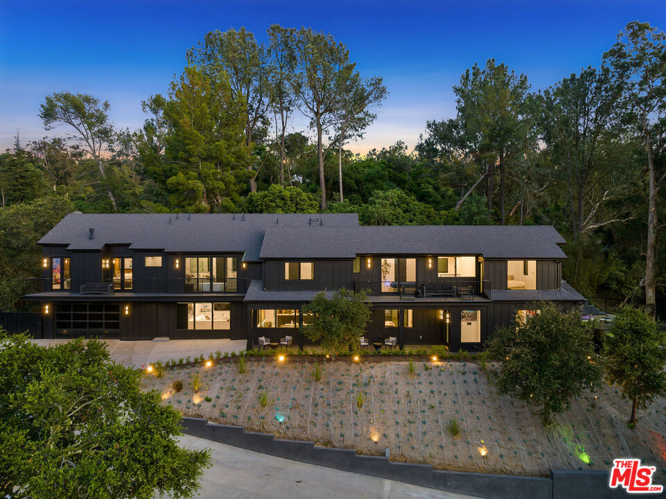 THE ROYAL OAK ESTATE This 4-1/2 acre unique parcel of land features a magnificent residence with guest house on an amazing, private compound surrounded by lush Oaks and beautiful greenery. The private driveway winds 3/4 of a mile off of Coldwater Canyon bringing you to the main house. Over 1000 mature protected Oak trees, roaming indigenous animals, hiking trails, and pristine views of Studio City and the mountains. This impeccably upgraded Farmhouse designed, finished home features 8 LARGE bedrooms, 7 full bathrooms plus 3 powder rooms and incredible amenities. Considered a completely smart home with Lutron automatic controlled lighting, automatic shades, intercom, cameras throughout the property, central music and security - nothing has been missed! Wolf/Subzero appliances in the gourmet kitchen and outdoor kitchen. Chef's paradise includes Miele built in coffee system, 2 dishwashers, massive island with brilliant lighting throughout. Entertaining is a breeze with the indoor-outdoor flow, full wet bar, refrigerated wine cellar and built-ins. White Oak hardwood floors throughout with Italian Porcelain and Quartz countertops exude beauty at every turn. All bedrooms have vaulted ceilings, en-suite baths and walk-in closets. Gorgeous views from the shared balcony for all "kids" bedrooms. An amazing master bedroom with 15' ceilings, private balcony, massive master closet and quintessential master bathroom with a kitchenette, his and hers toilets TOTO washlets top of the line, 100 sq ft master shower impeccably finished! Huge outdoor kitchen, bbq AND firepit with lovely dining area under dual heating elements and a central fan. Sparkling pool and spa with pool cover, waterfall and fire feature and outdoor bathroom and shower. Large back yard overlooking mature vegetation. Host your friends with an official pickleball court with basketball hoop! Fully powered golf carts for easy access across this massive compound. Property houses wild deer, goats, among other natural livestock. The parking garage and spaces to host over 50 cars for entertaining! This property is beautifully manicured with intense landscaping, outdoor lighting. You'll never tire of the beauty, fresh air, and activities at your fingertips. A quick 10-minute drive to Beverly Hills and 8-minute drive to Studio City and shopping.