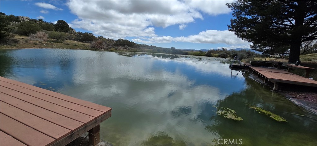 Country living close to the city with NO HOA! Welcome to your retreat nestled in the heart of Anza! Pull into this fully fenced and Electronic Gate impressive combined 7-bedroom, 3-bathroom stick-built home sits majestically on an expansive approximate 5-acre lot, offering the ultimate in luxury and serenity. 2 Home in one!
Step inside the main house boasting 4 bedrooms and 2 baths to discover a master bedroom sanctuary featuring an expansive walk-in closet with built-in shelving. The kitchen exudes elegance with French doors and gleaming granite countertops, seamlessly extending into both bathrooms for a harmonious design.
Adjacent to the main house, a separate dwelling with its own entrance awaits. This space features 3 bedrooms and 1 bath, perfect for hosting gatherings with its built-in bar and spacious dining area accented by two-story ceilings and floor-to-ceiling bay windows.
Step outside to your personal oasis, complete with a fully stocked "POND", and two outdoor cabanas. Enjoy acres of mostly flat, usable land, perfect for Horses, livestock and animals. Private hiking trails through the lush landscape.
Plenty of room is available for horses and storage for business owners with equipment. A private gate at the entrance and fully fenced perimeter ensures security and privacy for you and your loved ones.
Conveniently situated close to town yet secluded behind a protective hill, this property offers a peaceful and tranquil environment without compromising on accessibility. Indulge in the joy of harvesting fresh fruit from the numerous peach, apricot, and apple trees scattered throughout the landscape, complemented by mature pine, flowering crabapple, and flowering plum trees. Great water pressure with private well!
20 minutes to Wine Country Temecula and 35 minutes to Palm Desert!
Don't miss out on this extraordinary, one-of-a-kind property. Schedule your showing today and turn your dream home into a reality! This is a must see to truly appreciate the home and surroundings.