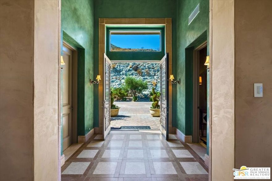 Old World charm meets desert luxury in the heart of Rancho Mirage. Nestled within a coveted enclave, 2 Nebulae Way offers the perfect balance of serene desert living and high-style luxury. This gated Tuscan-inspired estate embodies the romance of Mediterranean architecture with its warm stone facade, arched entryways, and rich craftsmanship, all set against the dramatic backdrop of the Santa Rosa Mountains. Designed for both intimate living and grand entertaining, the home features a chef-inspired kitchen with adjacent butler's pantry, spacious open concept living areas, and resort-style outdoor areas complete with a sparkling pool, spa, and multiple lounge settings. Whether hosting sophisticated soirees or enjoying tranquil mornings, every moment feels curated and exceptional.  This unique property was designed and built by the late noted desert developer and designer, Jim Baker, and is being offered with the custom furnishings created locally and especially by him for this home. Beyond the gates, Rancho Mirage offers world -class golf, fine dining, and the cultural vibrancy of Palm Springs just minutes away. 2 Nebulae Way is more than a home- it is a private sanctuary for those who appreciate privacy, beauty, and the art of desert living.