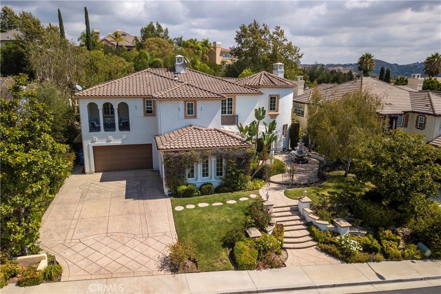 Welcome to Mont Calabasas, one of the most exclusive gated communities in Calabasas. This elegant estate greets you with a private courtyard featuring a tranquil water fountain and a pergola-covered sitting area, setting the tone for refined living.

Inside, a grand foyer with soaring ceilings and a dramatic circular staircase bathed in natural light makes an immediate impression. The home has been updated with new flooring and fresh interior paint throughout. Formal living and dining rooms, each with a fireplace, provide timeless settings for entertaining. A spacious family room with a fireplace opens seamlessly to the chef’s kitchen, appointed with a center island, granite counters, new double ovens, microwave, wine refrigerator, and a built-in 48-inch stainless steel refrigerator. A breakfast nook and island seating complete the space.

The nearly half-acre grounds are a private resort, offering a sparkling pool, spa, water features, multiple outdoor seating areas, and a built-in BBQ for alfresco dining.

Designed for both comfort and function, the floor plan includes one bedroom and a dedicated office downstairs, plus four bedrooms and an additional upstairs family room. The luxurious primary suite is a private retreat with a sitting area, fitness room, spa-like bath with dual vanities, oversized walk-in closets, and balconies overlooking the park-like grounds.

Additional highlights include a whole-house water treatment system and thoughtful upgrades throughout. This residence blends timeless elegance with modern amenities, delivering the ultimate Calabasas lifestyle.
