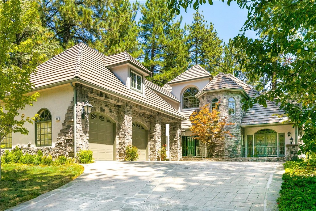 Perfectly located along the prestigious Lake Arrowhead Mountain resort community, this stunning custom home offers an unparalleled blend of luxury, elegance, and serene natural beauty. Situated directly on the Lake Arrowhead Country Club golf course, the residence boasts breathtaking views of the lush fairways and lake, making it a golfer's paradise and a nature lover's dream.
Every detail in this home has been meticulously crafted with the highest quality materials and finishes. The grand entrance welcomes you with soaring ceilings, rich hardwood floors, and an abundance of natural light pouring in through expansive windows. The open-concept living area is perfect for entertaining, featuring a cozy stone fireplace, custom built-ins, and seamless access to a spacious outdoor patio overlooking the 7th Tee box, where you can enjoy morning coffee or evening sunsets.
The gourmet kitchen is a chef’s delight, equipped with top-of-the-line appliances, custom cabinetry, and a large center island and breakfast area with fireplace overlooking the golf course. The adjoining dining area is perfect for hosting intimate dinners or large gatherings, all while enjoying the stunning views.
Retreat to the luxurious primary suite, complete with a spa-like bathroom, walk-in closet, fireplace, and private access to the deck. Additional bedrooms are generously sized, each offering their own unique charm and views, most are en-suites.
Outside, the beautifully landscaped grounds provide a peaceful oasis, with mature trees, lush greenery, and direct access to the golf course. The home’s exterior is equally impressive, featuring custom stonework, a three-car garage, patio perfect with built-n BBQ area, for outdoor living. In addition to an oversized 3-car garage, there is also a separate golf cart garage with direct access to the course.
This home is not just a place to live, but a lifestyle. Located in a sought-after mountain resort community, residents enjoy access to world-class amenities including golf, hiking, skiing, dining, and access to a private lake. Sellers have a boat dock and Pontoon boat also available. Whether you’re seeking a full-time residence or a vacation retreat, this exceptional property offers the perfect blend of luxury, comfort, and natural beauty.
