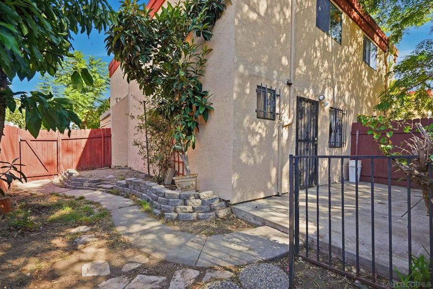 Corner-unit townhome in a gated community with the largest private yard, private balcony, and upgrades throughout! This 2-bed, 1.5-bath home offers an open floor plan, bright kitchen, and in-unit laundry. The spacious yard is perfect for entertaining, pets, or relaxing—a rare find under $500K! Enjoy low HOA fees, added security, and a prime El Cajon location near parks, shopping, dining, and freeway access.