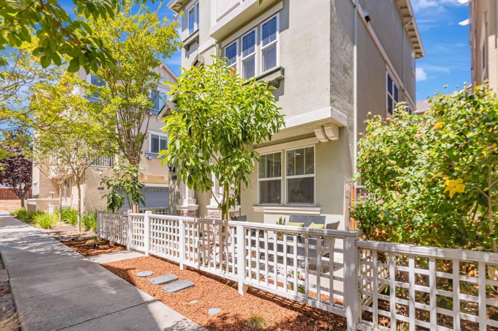 Tucked away on a quiet cul-de-sac, this 12-year-new single-family home offers 3 bedrooms, a dedicated office, 2 full bathrooms, and 2 half baths in a bright, open-concept layout. The light-filled great room opens to a private balcony, perfect for relaxing or entertaining. The gourmet kitchen features a central island, modern cabinetry, expansive granite countertops, and brand-new stainless steel appliances including range, oven, stove, dishwasher, and new exhaust fan. New vinyl plank flooring and fresh interior paint enhance the home throughout. The first floor includes a private office and half bath, ideal for working from home or potential 4th bedroom. Refreshed bathrooms showcase contemporary finishes, while the expansive primary suite boasts a walk-in closet, dual vanities, oversized shower, and updated lighting. Beautifully refinished front yard and stamped concrete side yard. Enjoy access to scenic walking and biking trails and nearby amenities like Elizabeth Lake, Central Park, and Aqua Adventure Water Park. Community perks include a basketball court and playground. Located in the sought-after Fremont School District with easy access to Hwy 680, Fremont Blvd, shopping, and schools. A rare opportunity for modern living in one of Fremont's most desirable neighborhoods!