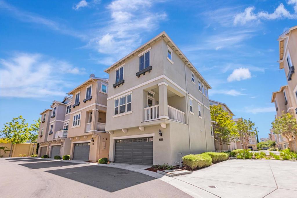 Tucked away on a quiet cul-de-sac, this 12-year-new single-family home offers 3 bedrooms, a dedicated office, 2 full bathrooms, and 2 half baths in a bright, open-concept layout. The light-filled great room opens to a private balcony, perfect for relaxing or entertaining. The gourmet kitchen features a central island, modern cabinetry, expansive granite countertops, and brand-new stainless steel appliances including range, oven, stove, dishwasher, and new exhaust fan. New vinyl plank flooring and fresh interior paint enhance the home throughout. The first floor includes a private office and half bath, ideal for working from home or potential 4th bedroom. Refreshed bathrooms showcase contemporary finishes, while the expansive primary suite boasts a walk-in closet, dual vanities, oversized shower, and updated lighting. Beautifully refinished front yard and stamped concrete side yard. Enjoy access to scenic walking and biking trails and nearby amenities like Elizabeth Lake, Central Park, and Aqua Adventure Water Park. Community perks include a clubhouse and playground. Located in the sought-after Fremont Washington School District with easy access to Hwy 680, Fremont Blvd, shopping, and schools. A rare opportunity for modern living in one of Fremont's most desirable neighborhoods!