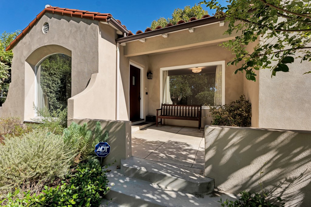 Welcome to this beautifully maintained 1,408 sq. ft. Spanish-style home, blending original character with tasteful updates. The front yard features drought-tolerant landscaping, setting the tone for this warm and inviting property. Step inside to find coved ceilings, gorgeous wood floors, a cozy fireplace, and large windows that flood the living room with natural light. The updated kitchen boasts newer cabinetry, granite countertops, and Viking appliances, perfect for both everyday cooking and entertaining. The primary suite offers a walk-in closet, a stylishly updated en-suite bathroom, and French doors that open to a private backyard deck. A second bedroom also features French doors with direct yard access, while the hall bathroom has been thoughtfully updated to complement the home’s original charm. An indoor laundry area adds everyday convenience. Outdoors, the lush backyard is dotted with fruit trees and provides plenty of space to relax or entertain. A detached two-car garage with an additional bonus room offers flexibility for storage, a workshop, or creative use. Centrally located and close to everything, this special home is a rare find.