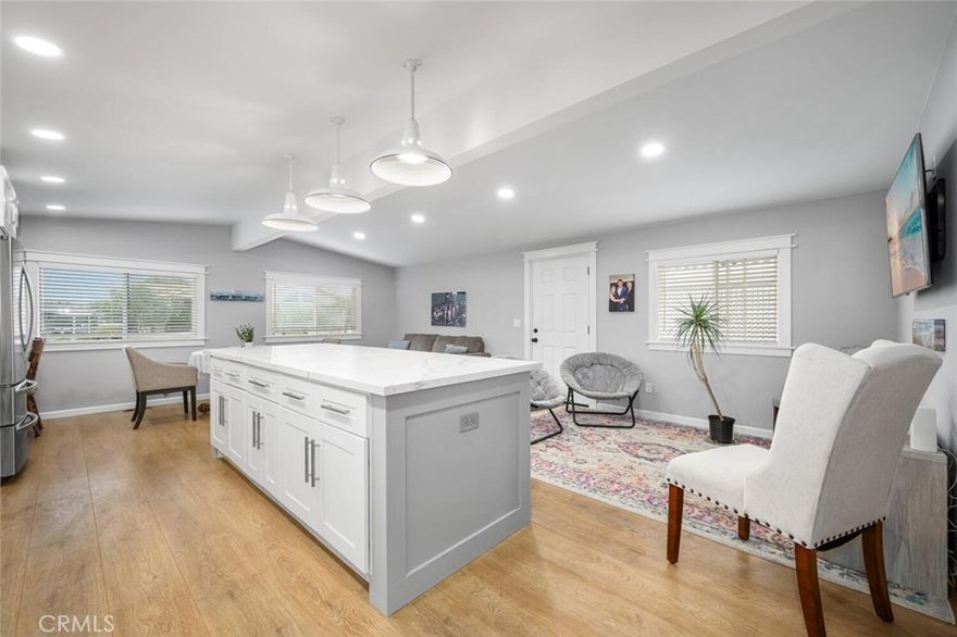 This 55+ community home really delivers, situated in the highly desirable Rancho del Rey Mobile Home Estates. Convenient to sandy beaches, wetland hiking trails, shopping, restaurants, freeways and much more. Community features include gated entry with fulltime security guard, two clubhouses each with heated pools, Jacuzzi spas, sauna, banquet facilities, billiard tables, outside barbeque areas. This home's kitchen is its crown jewel! Custom kitchen island with quartz tops. Recessed lighting. Double pained windows. 20 Piers under the home to handle increased weight. Great location facing west for ocean breeze and sunsets. Guest parking very close and walk to clubhouse and pool!